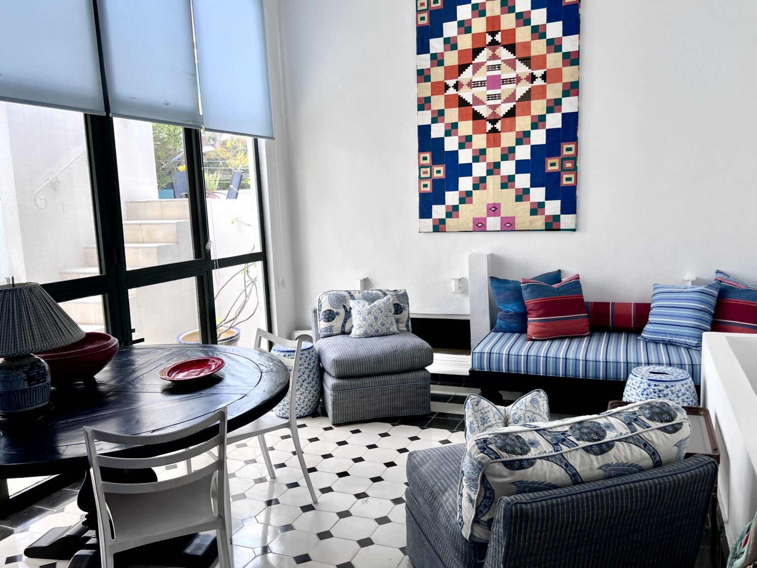 Cozy sunlit living room with blue striped furniture
