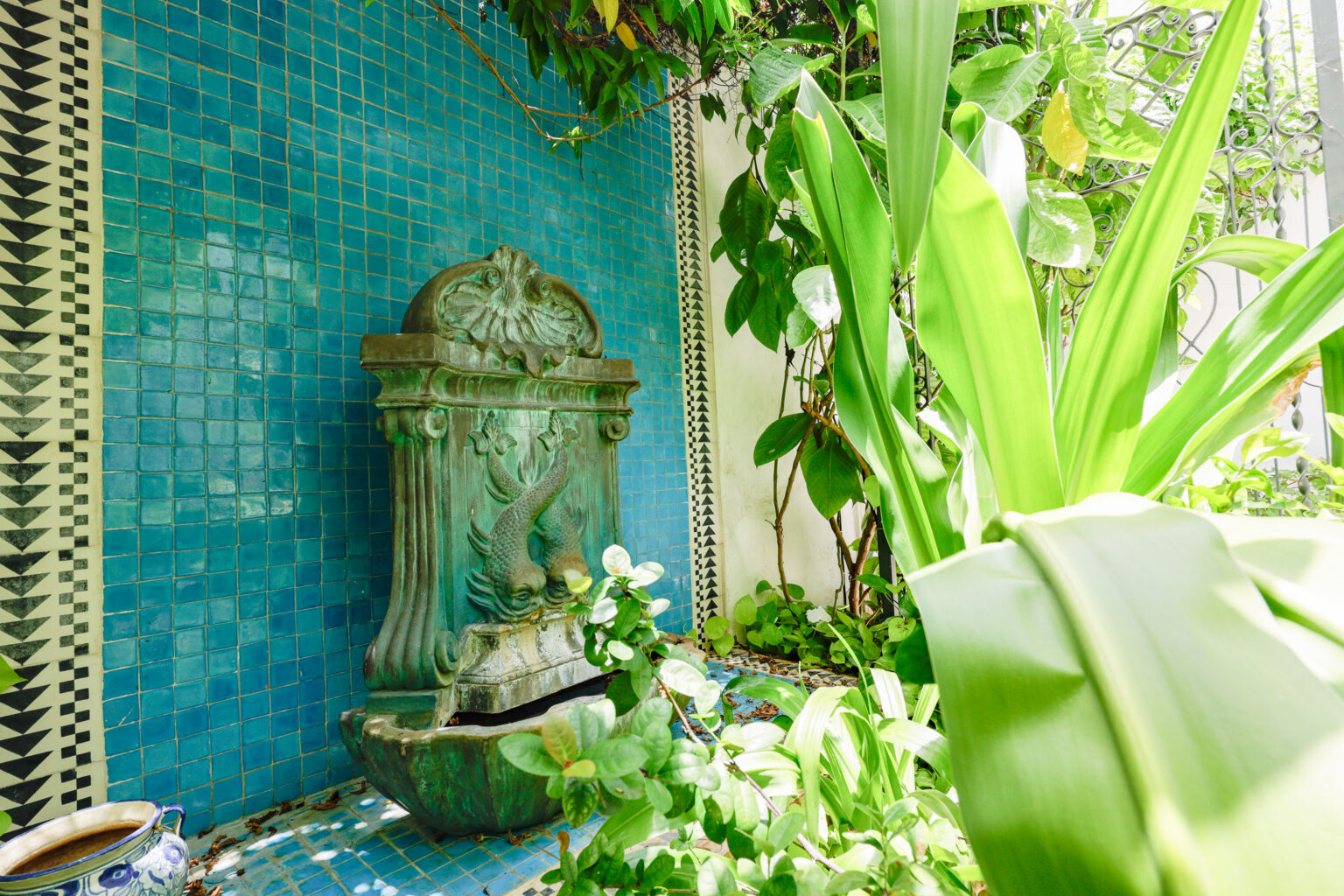 Ornate garden fountain with turquoise tiled wall