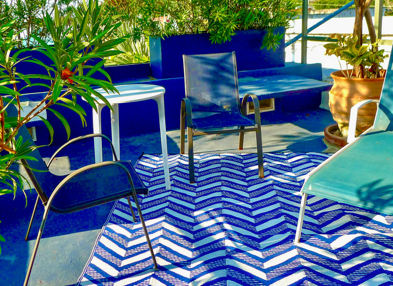 Blue patio seating with chevron patterned rug