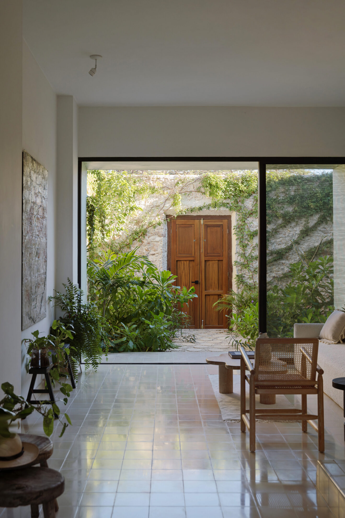 Living room with plants and wooden courtyard door