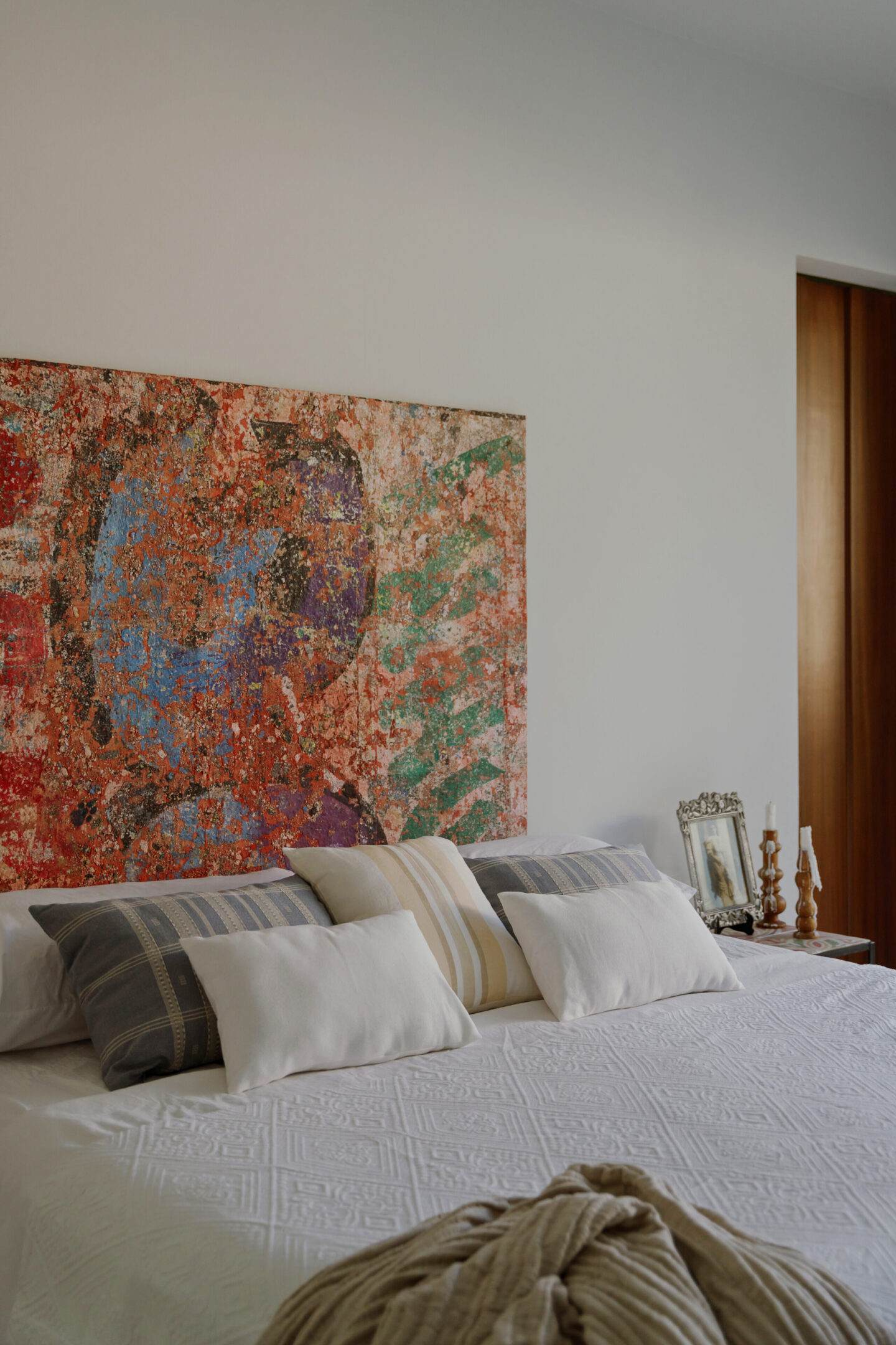 Bedroom with colorful abstract headboard