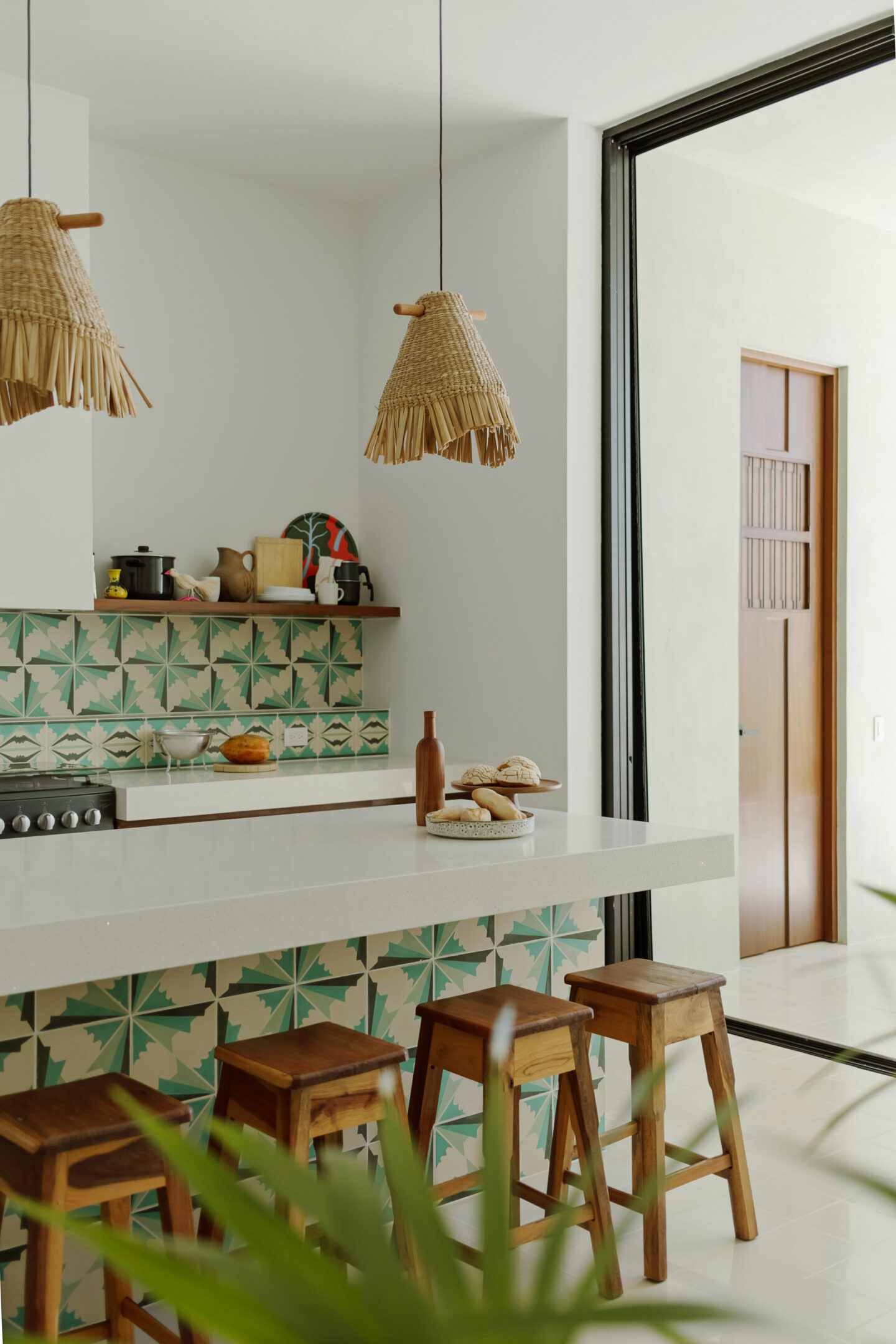 Modern kitchen island with patterned tile and stools