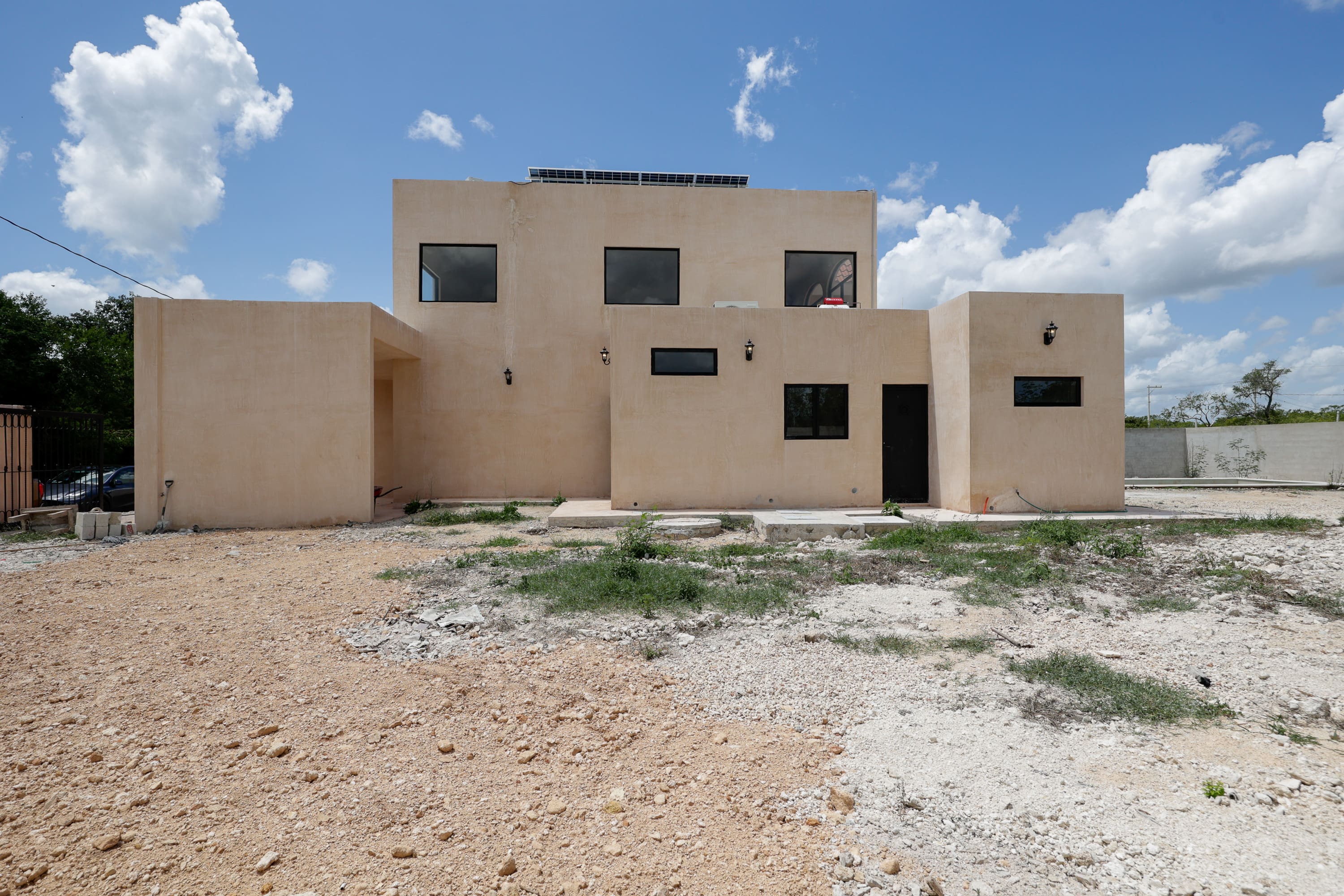 Modern beige two-story home with flat roof