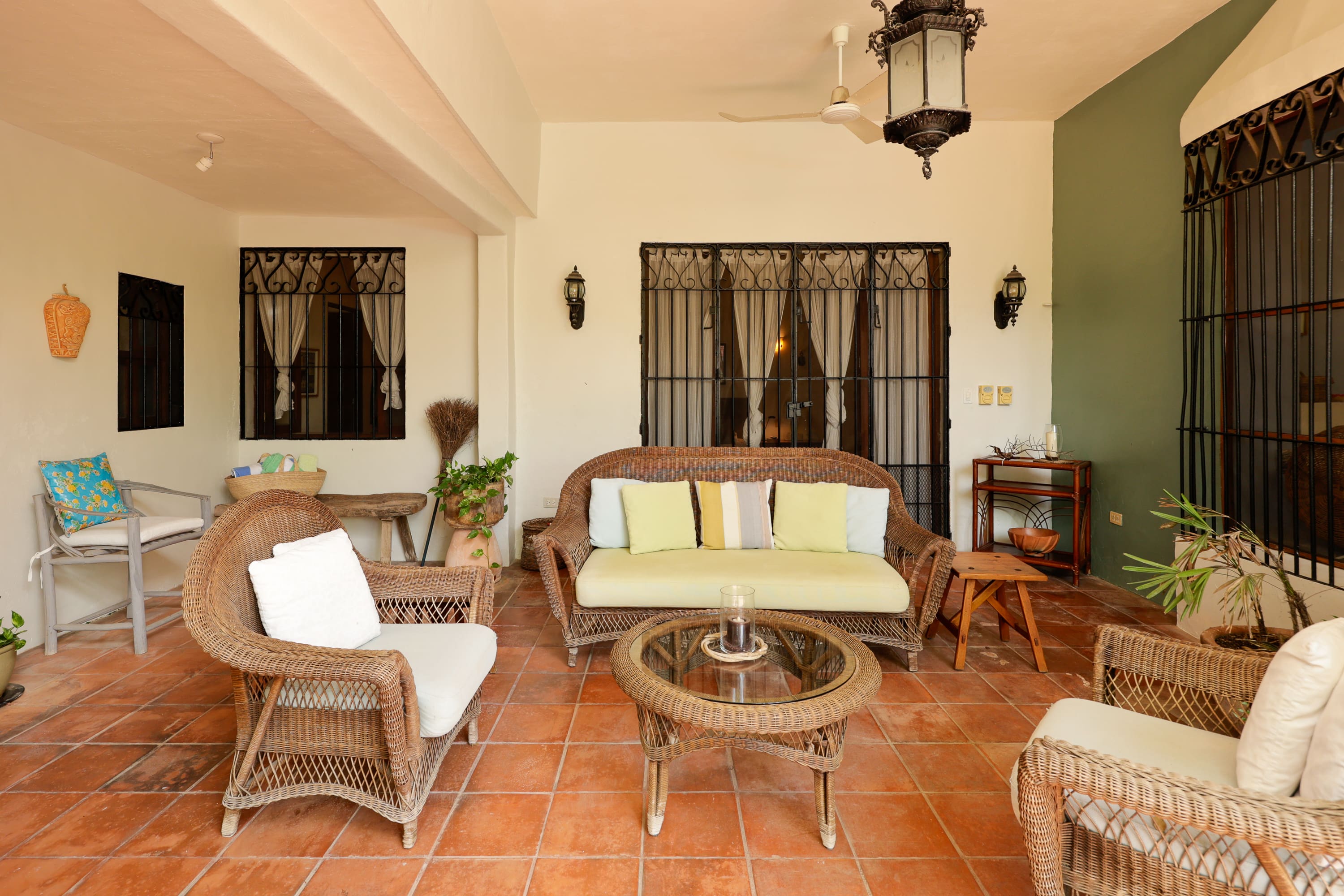 Wicker patio seating with cushions and plants