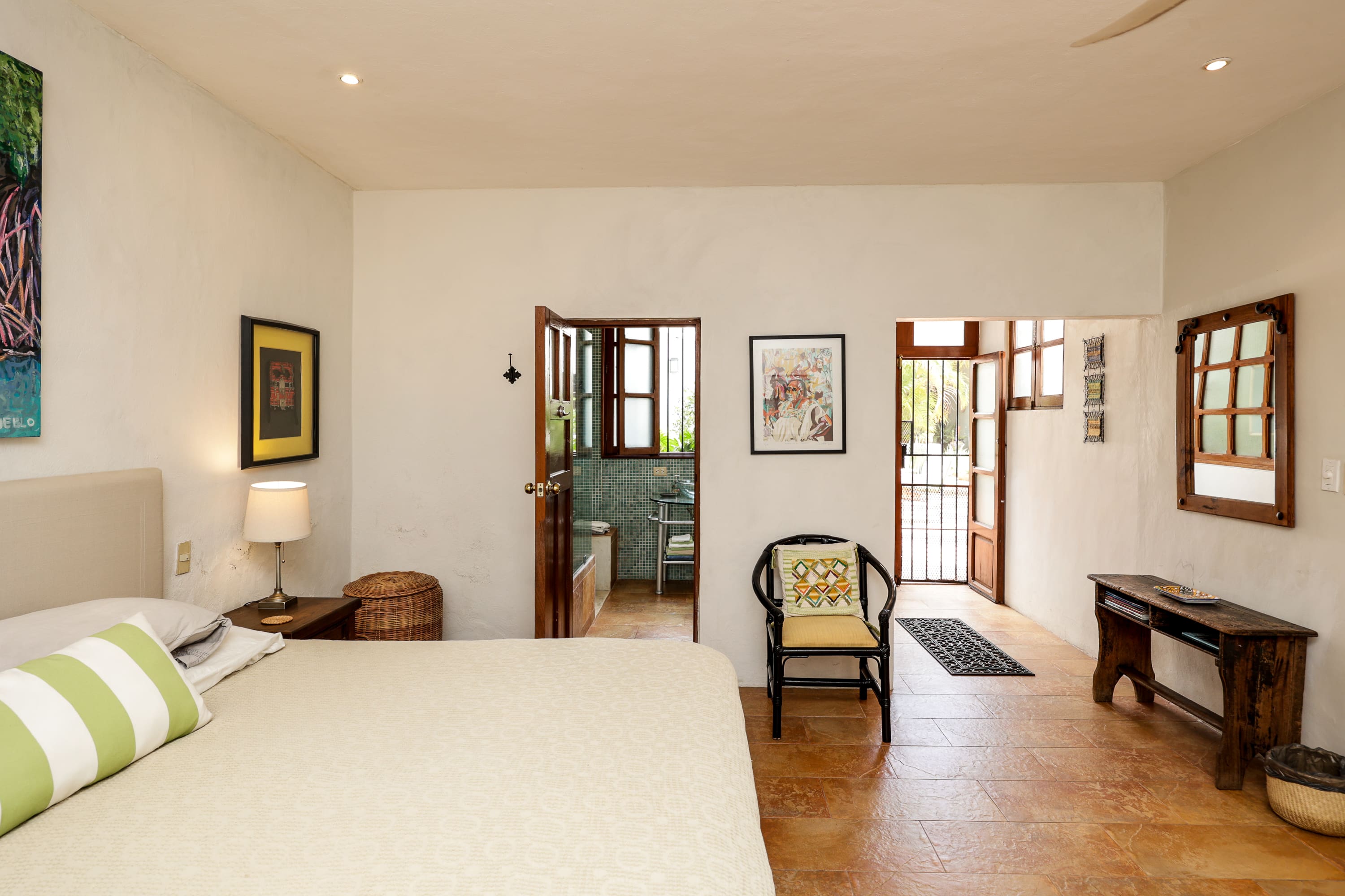 Light-filled bedroom with bed and open doors