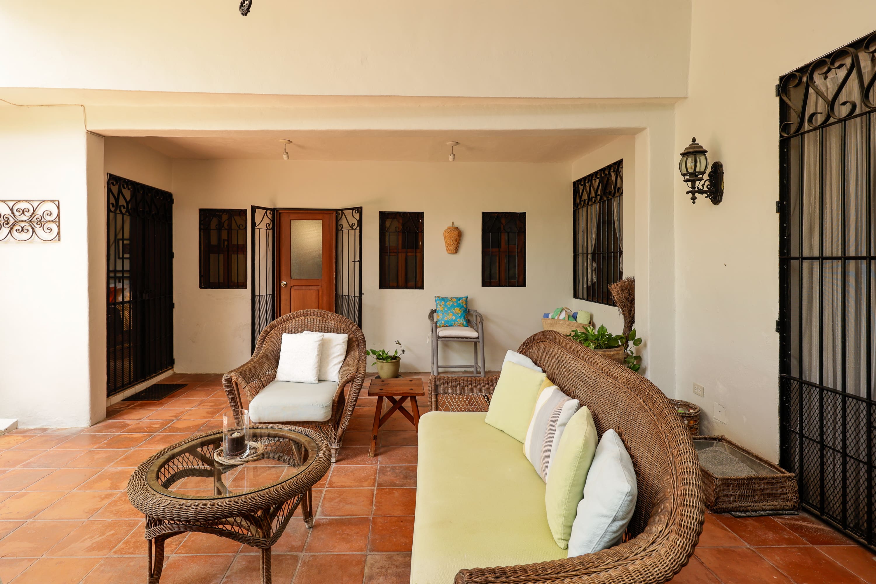 Covered patio with wicker seating and cushions