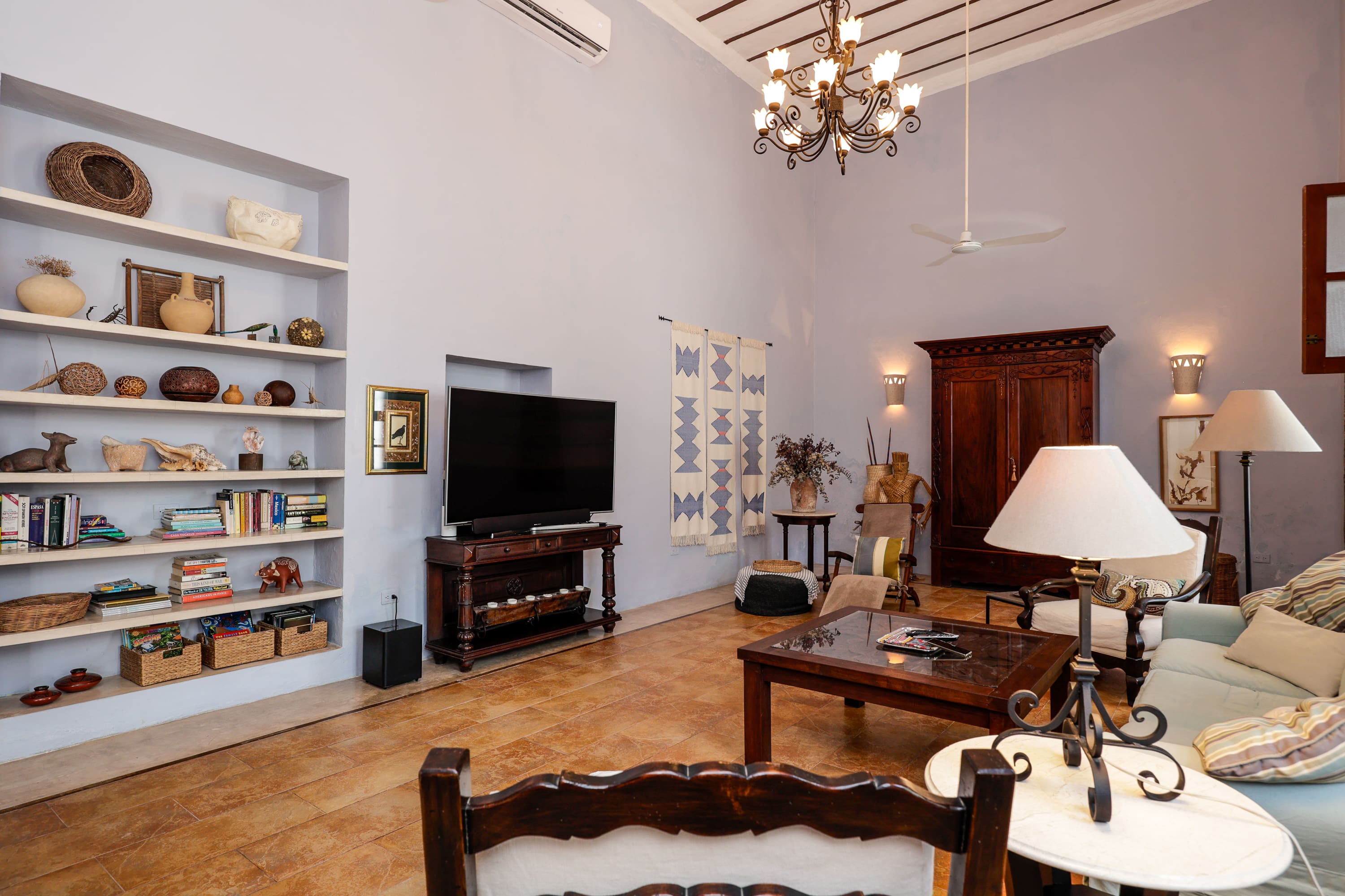 Spacious living room with chandelier and TV