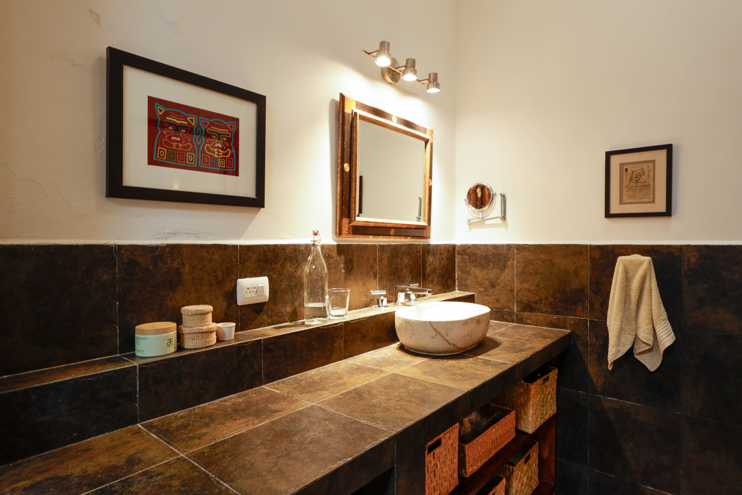 Stone-tiled bathroom vanity with vessel sink