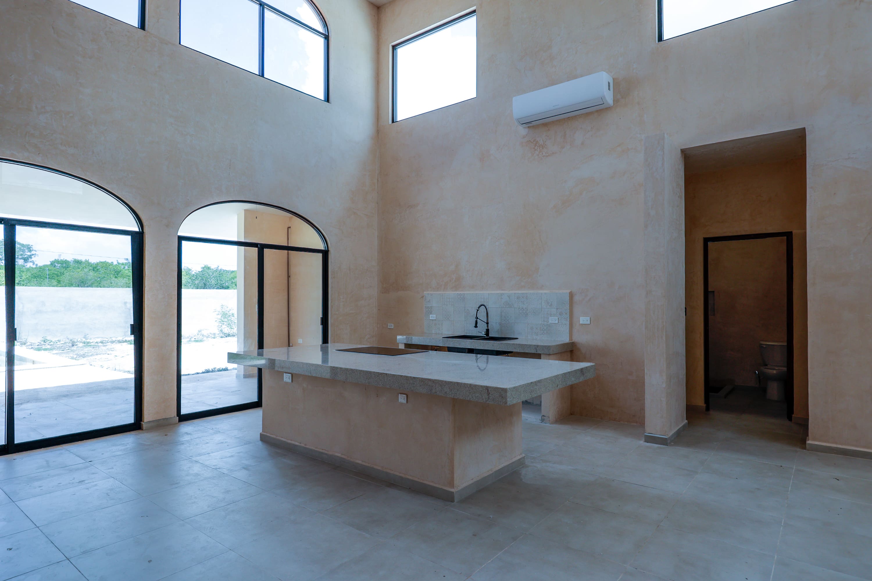 Minimalist kitchen with island and arched windows