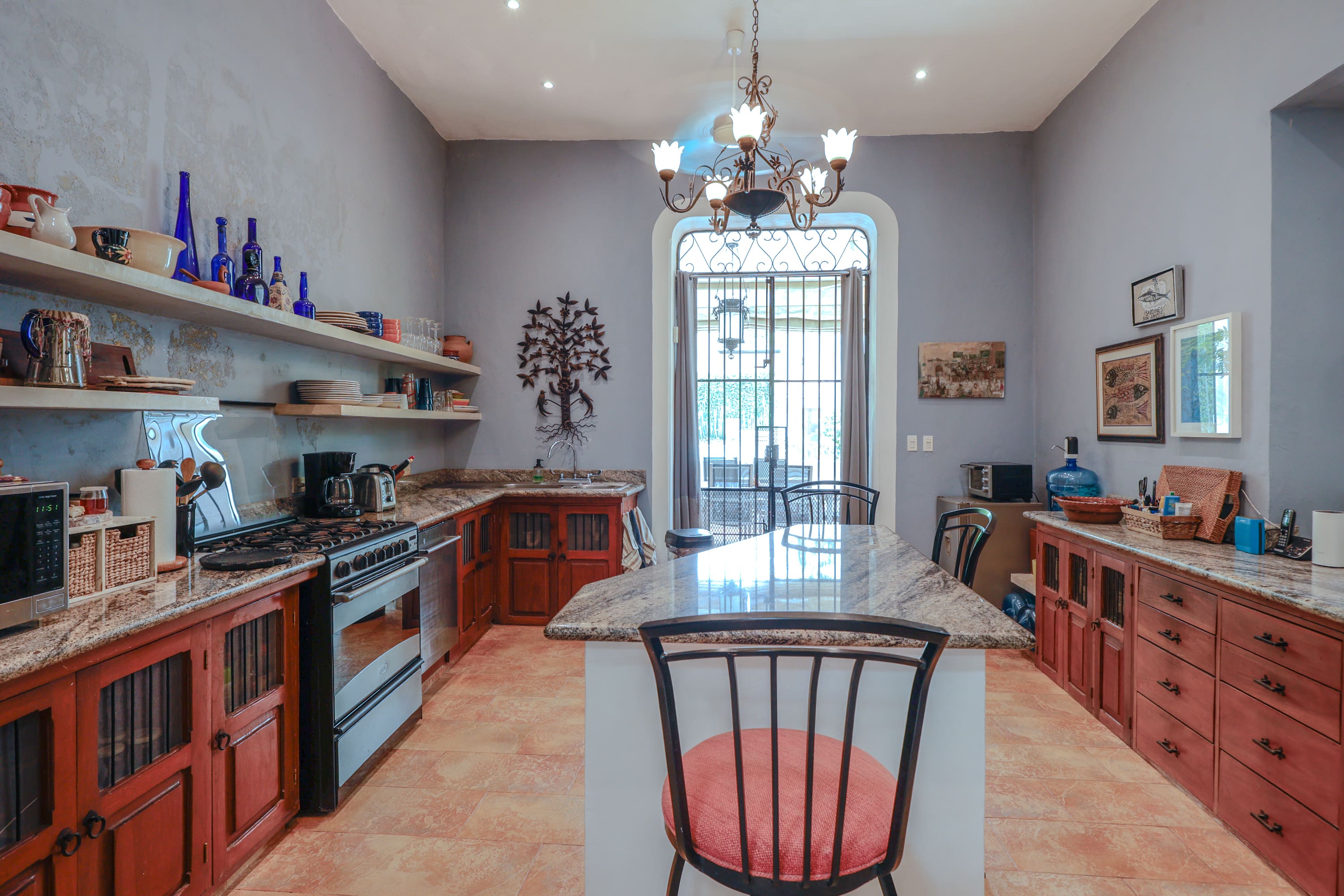 Rustic kitchen with granite island and chandelier