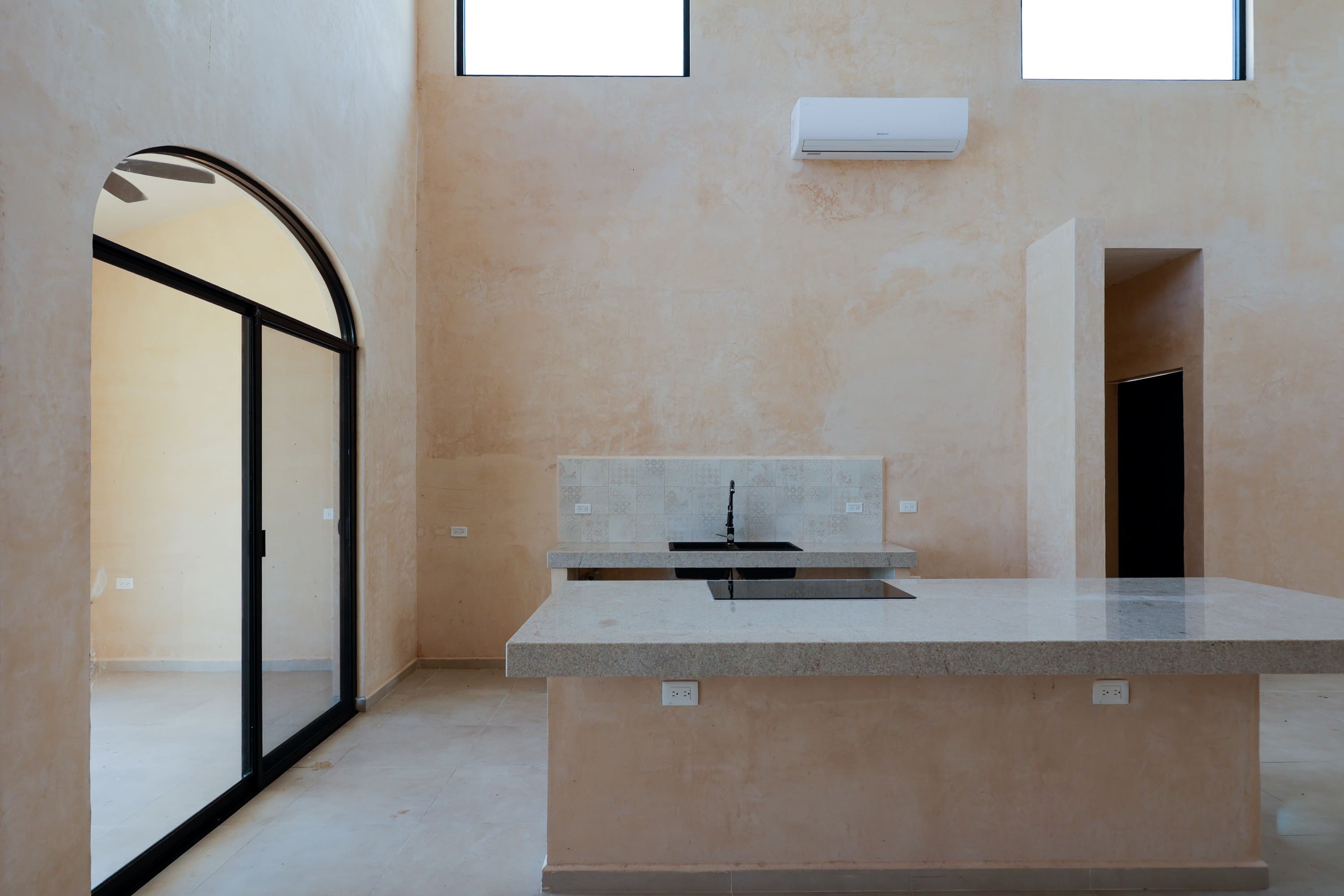 Minimalist beige kitchen with large island
