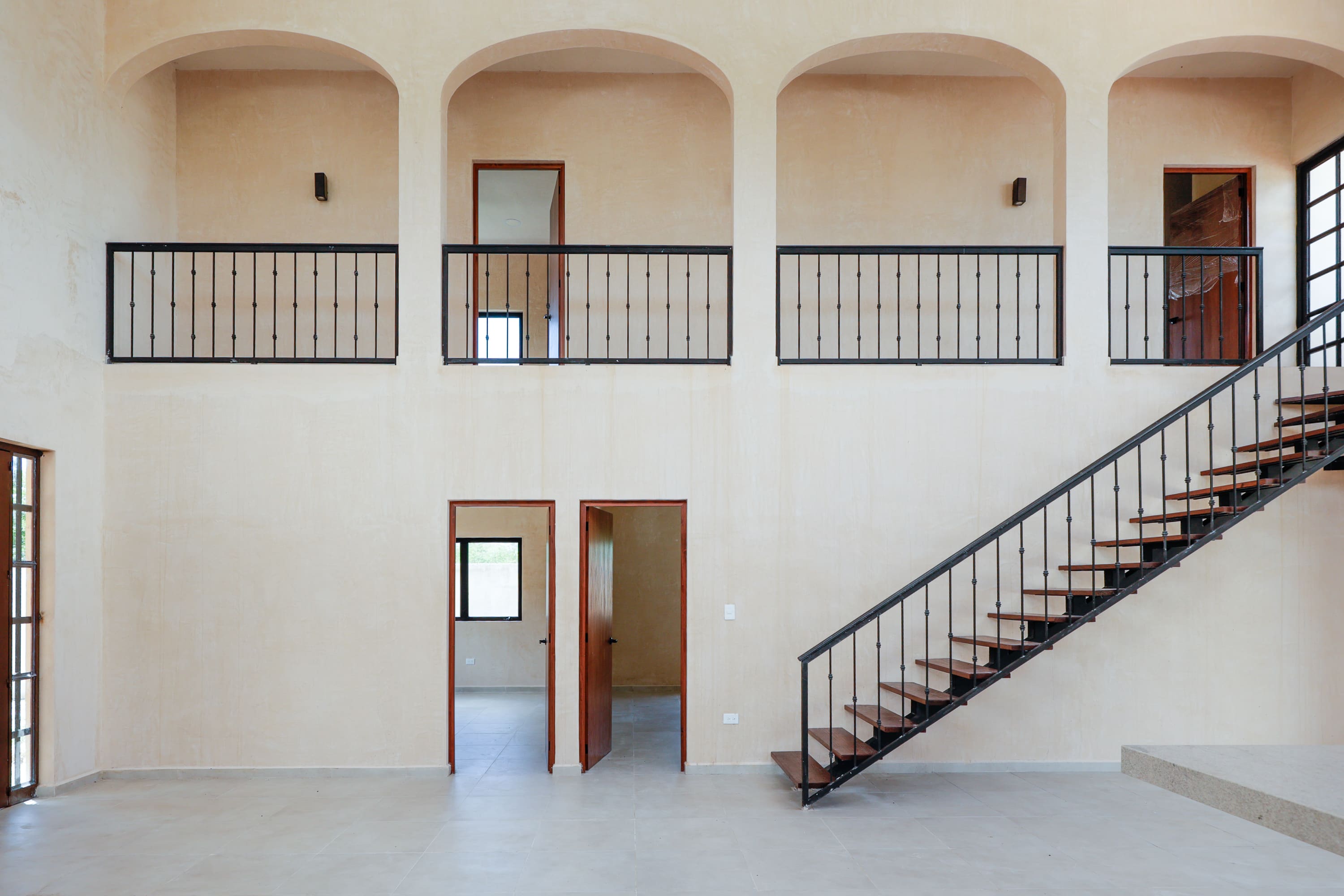 Minimalist interior with metal staircase and balconies