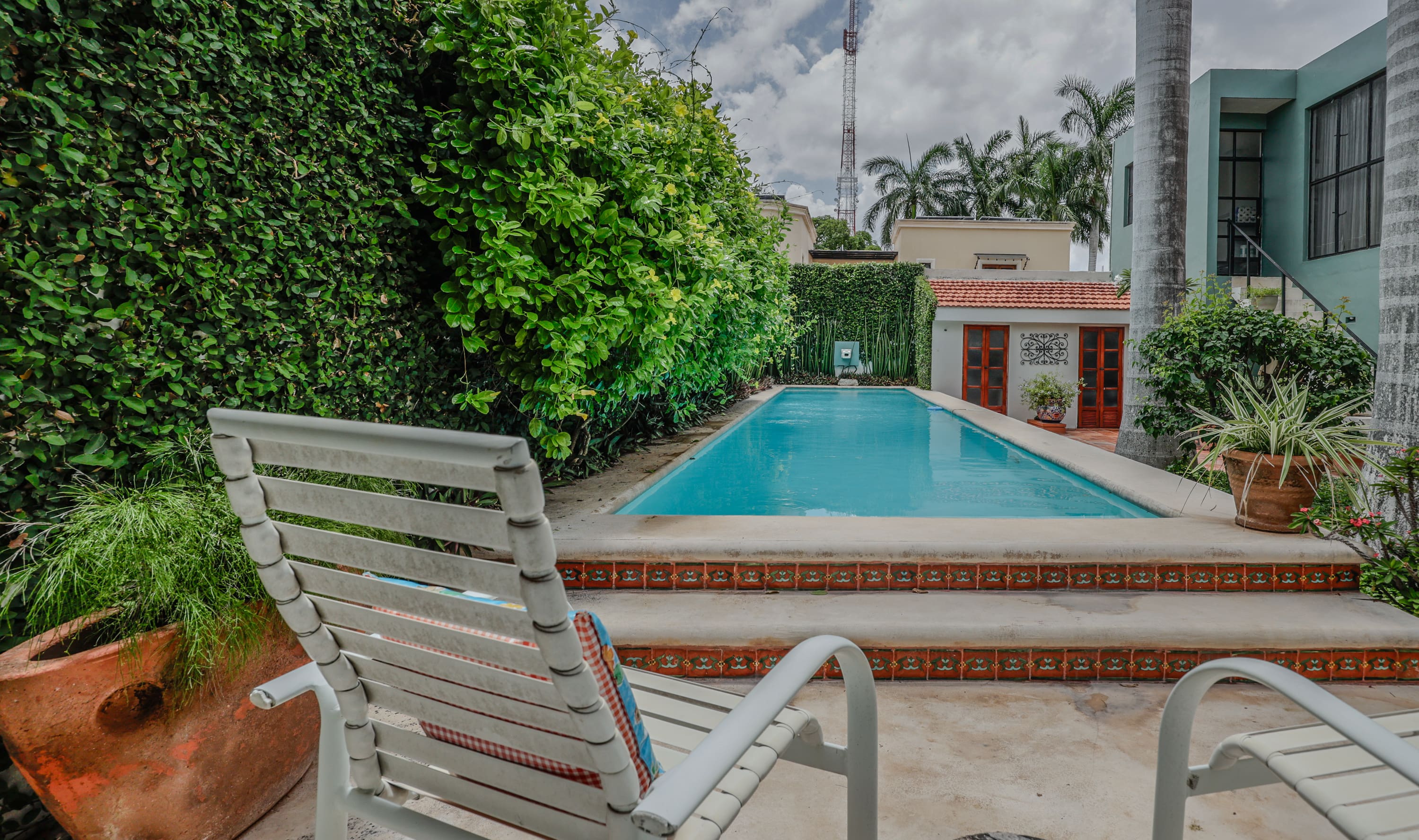 Backyard swimming pool with lounge chairs