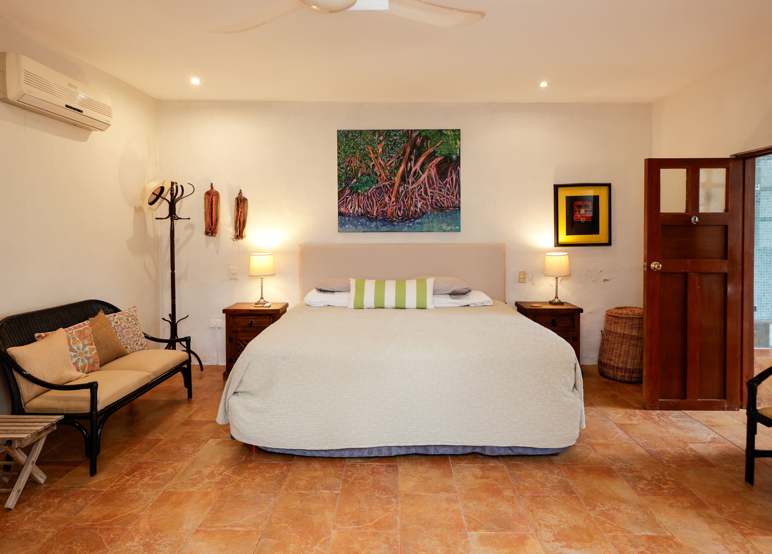 Cozy bedroom with king bed and artwork
