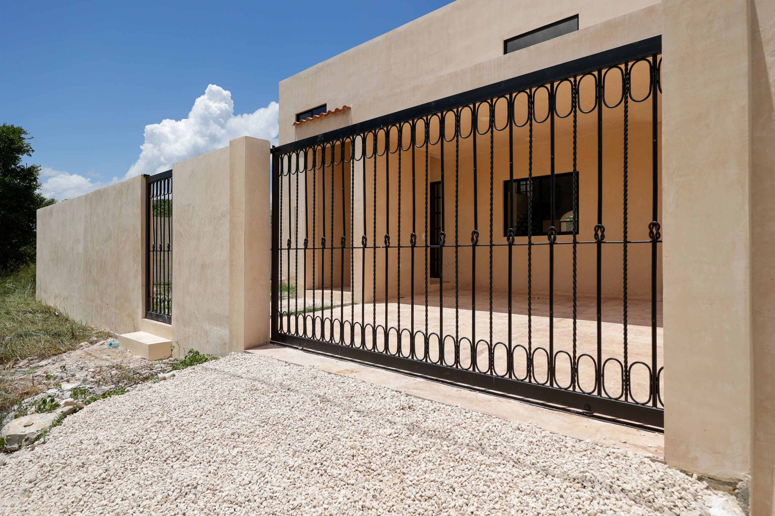 Modern house with black wrought iron gate