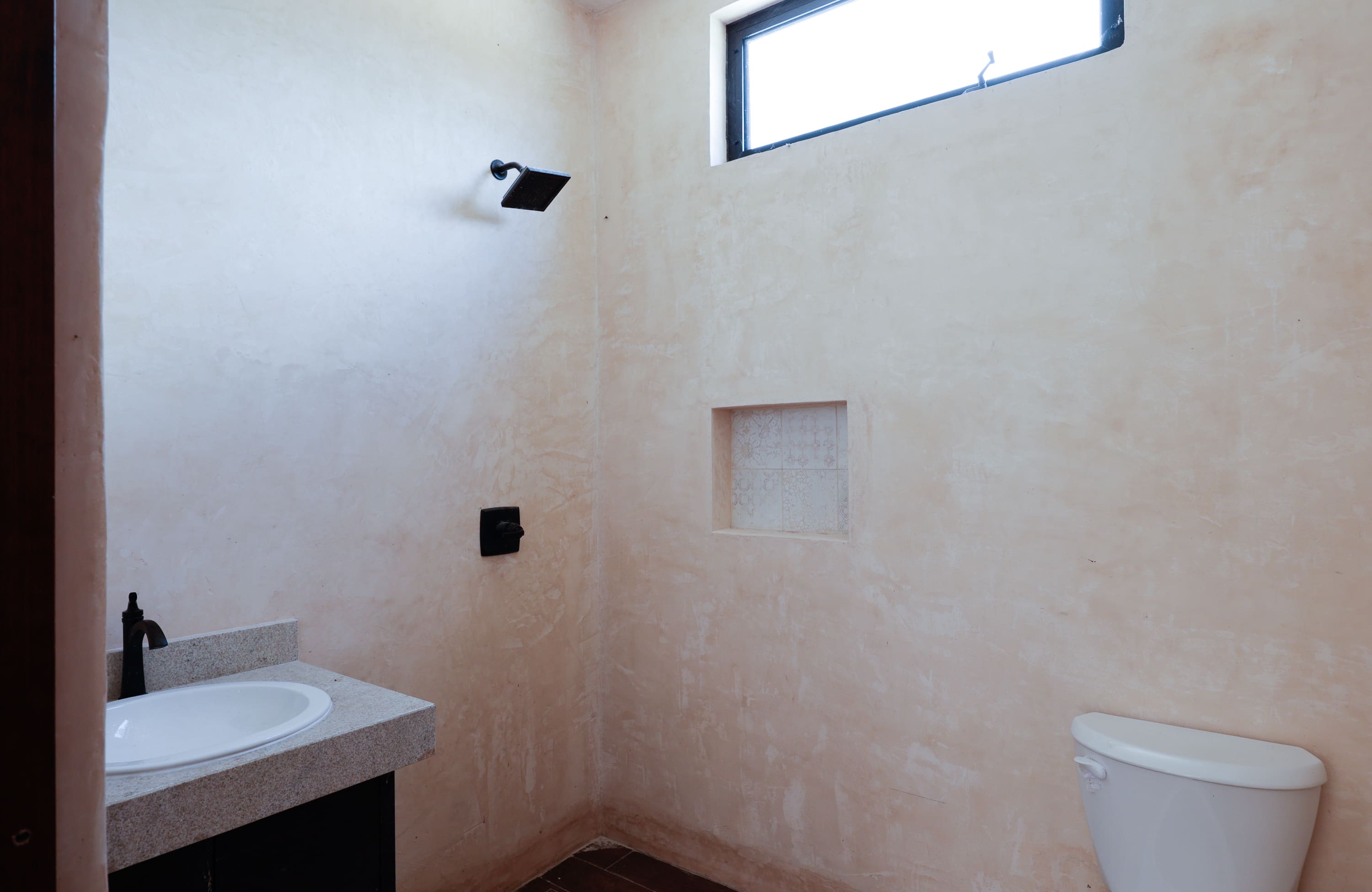 Minimalist beige bathroom with sink and toilet