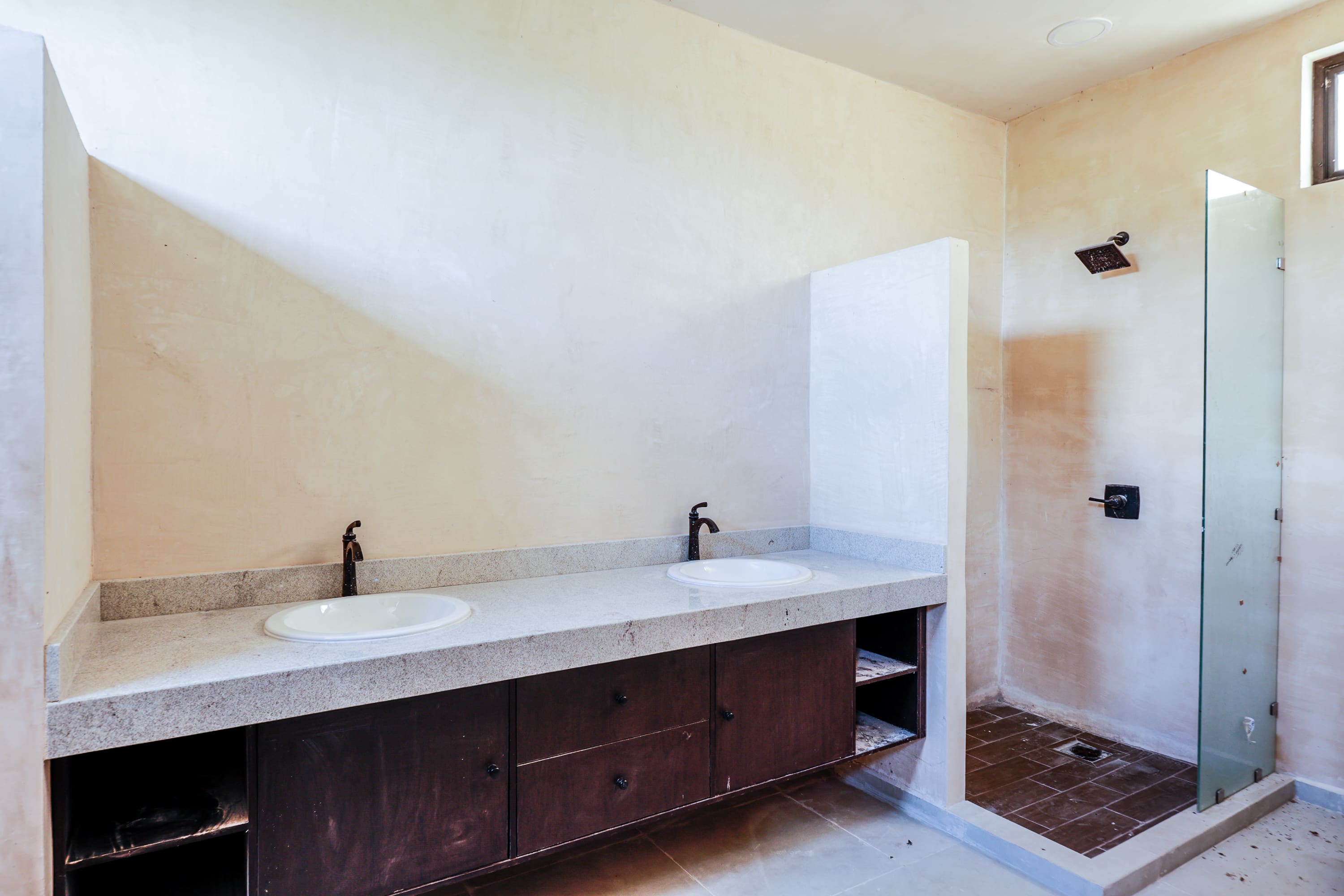 Bathroom with double vanity and glass shower