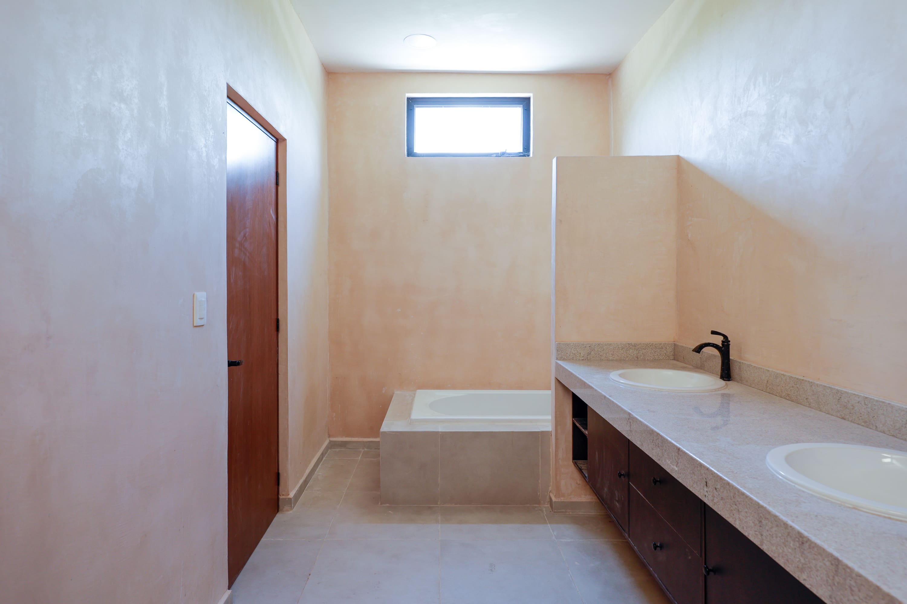 Minimalist bathroom with bathtub and double vanity