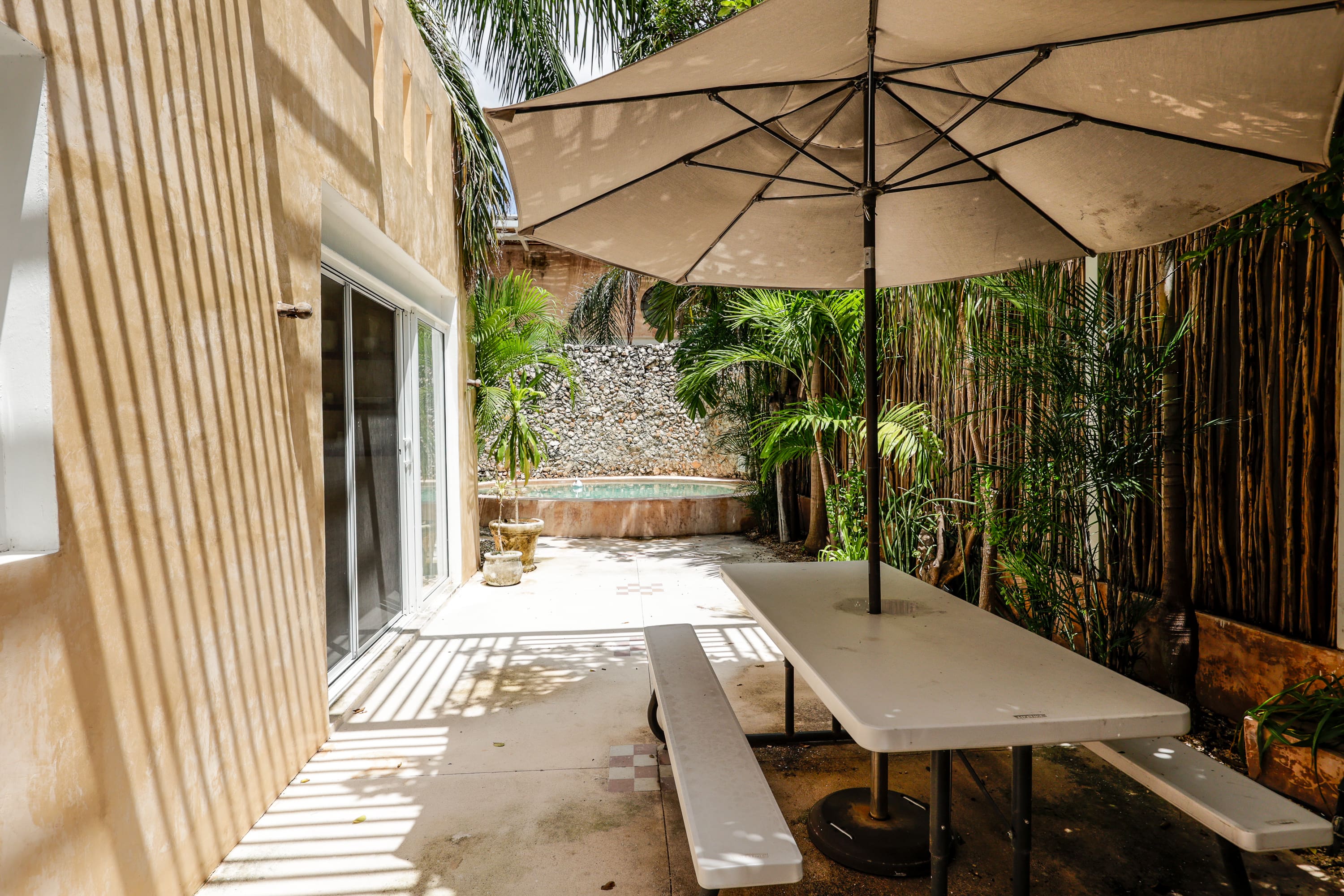 Shaded patio with picnic table and umbrella