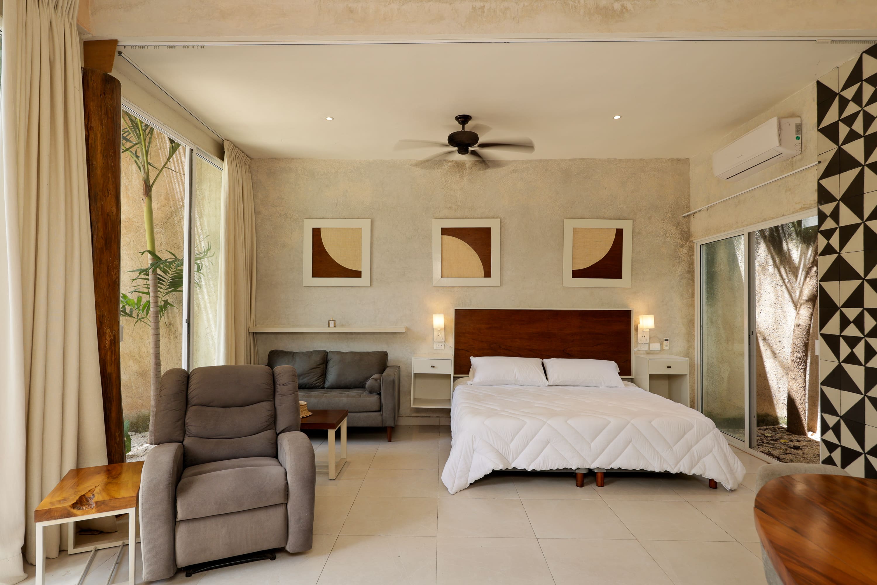 Modern hotel bedroom with bed and armchair
