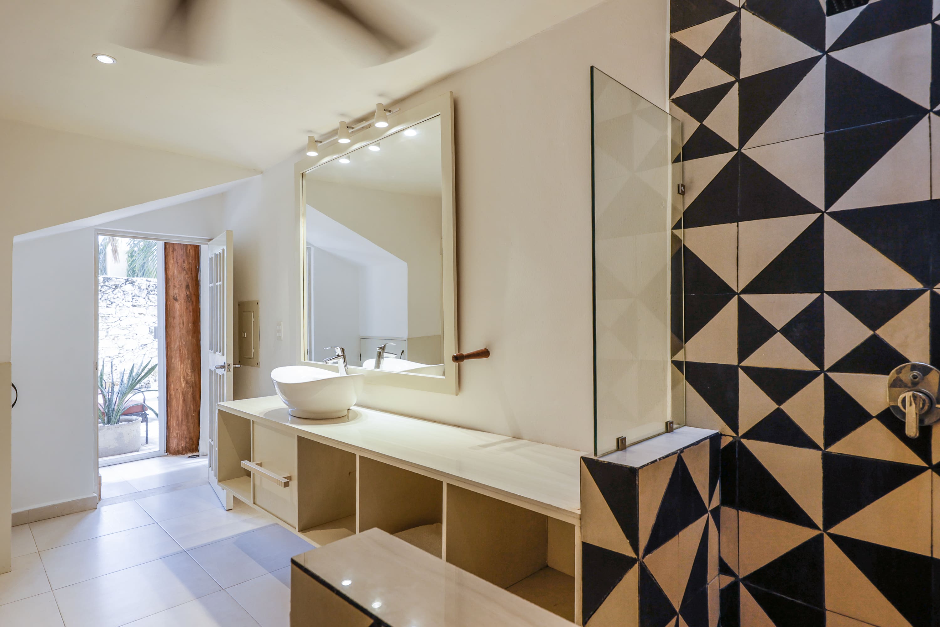 Bright bathroom with vessel sink and geometric tiles