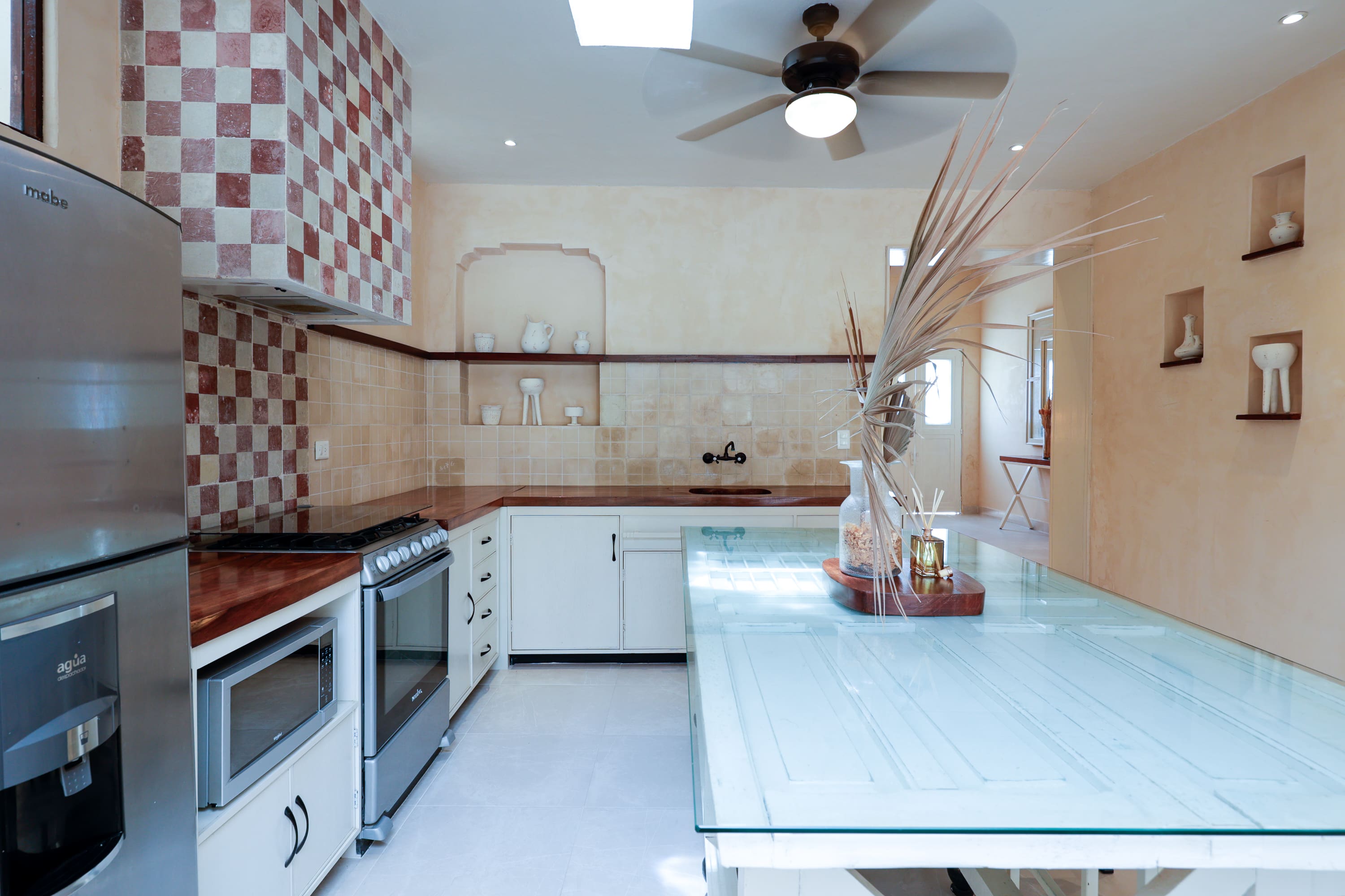Bright modern kitchen with glass island