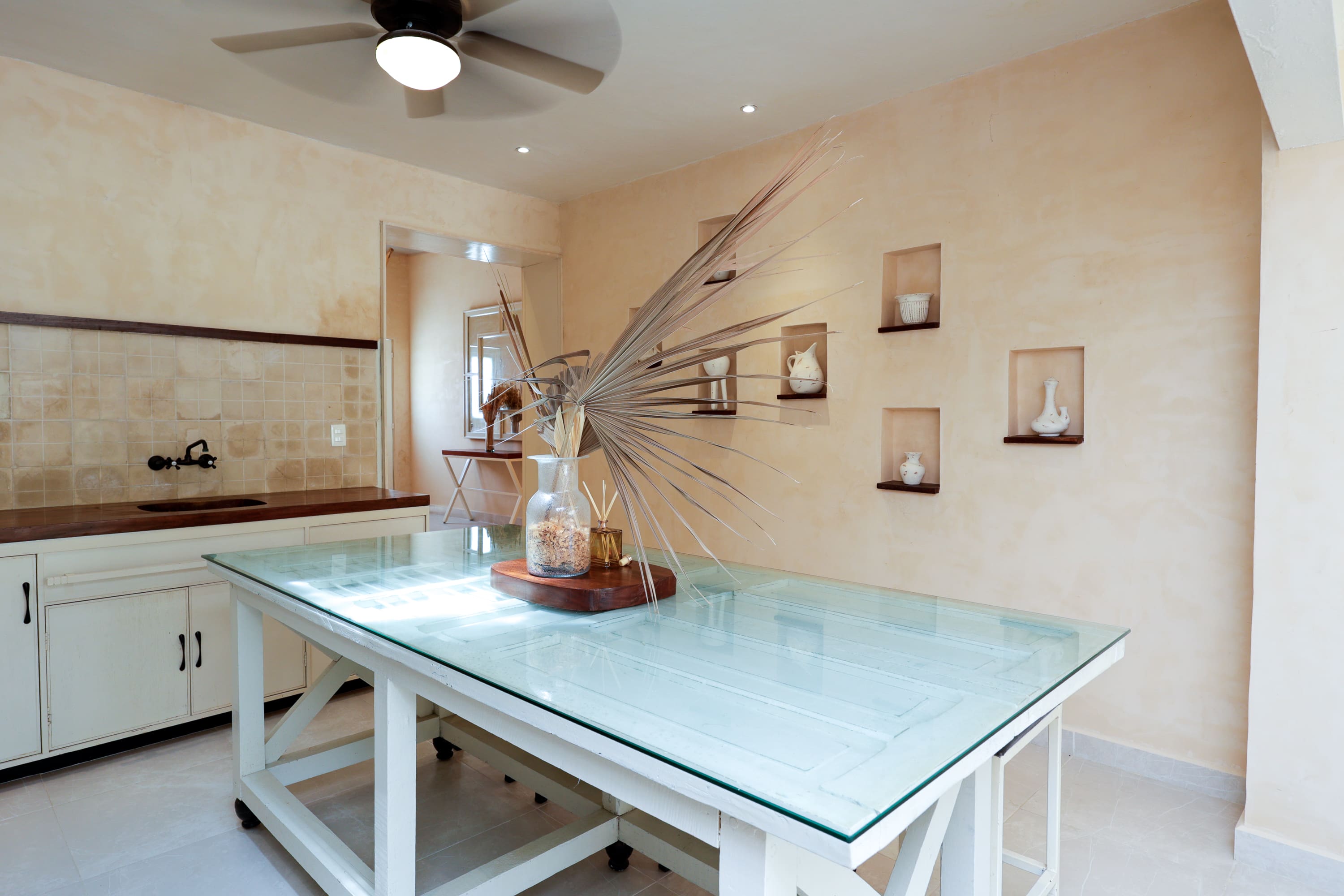 Dining room with glass-top table and centerpiece