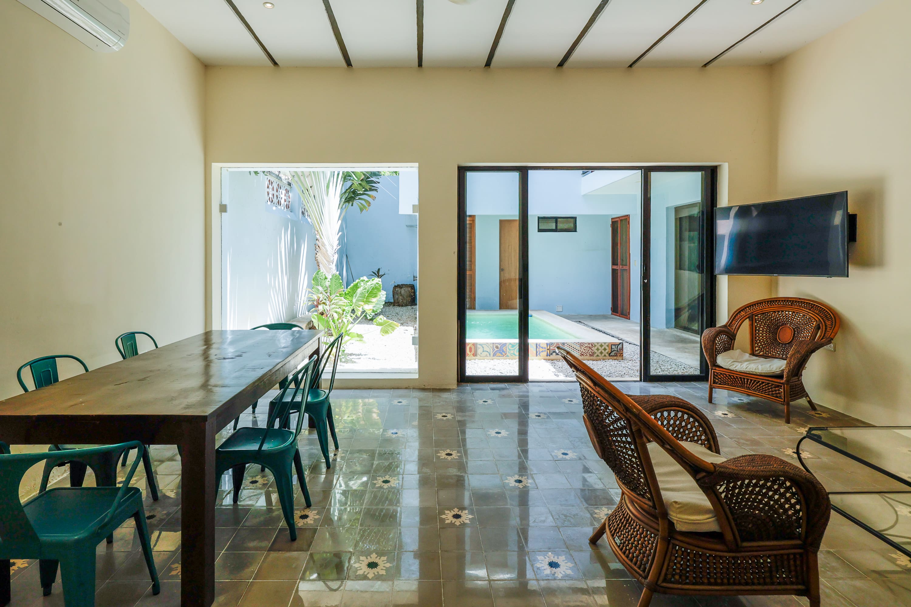 Indoor dining and seating area overlooking pool