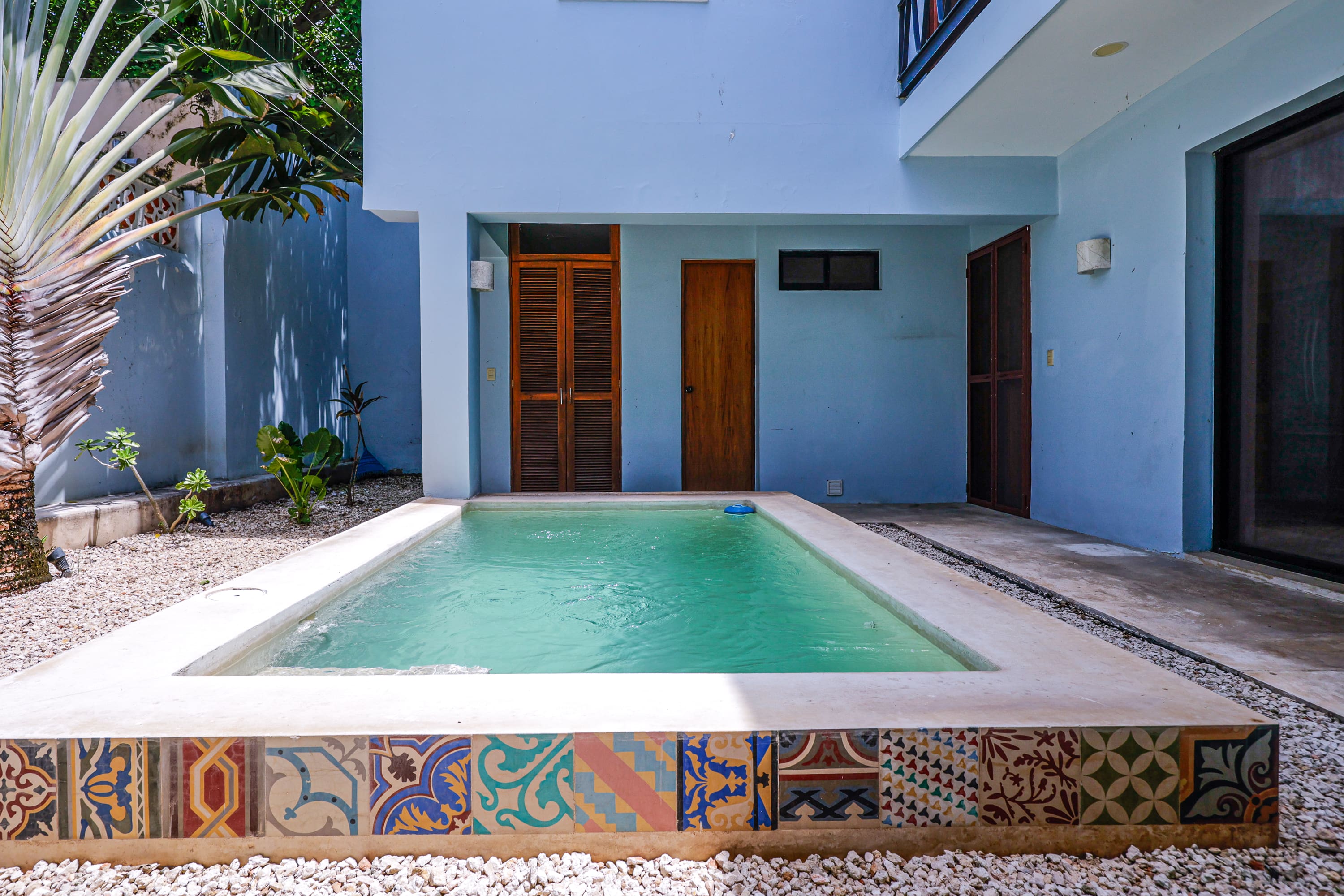 Private courtyard pool with decorative tile border
