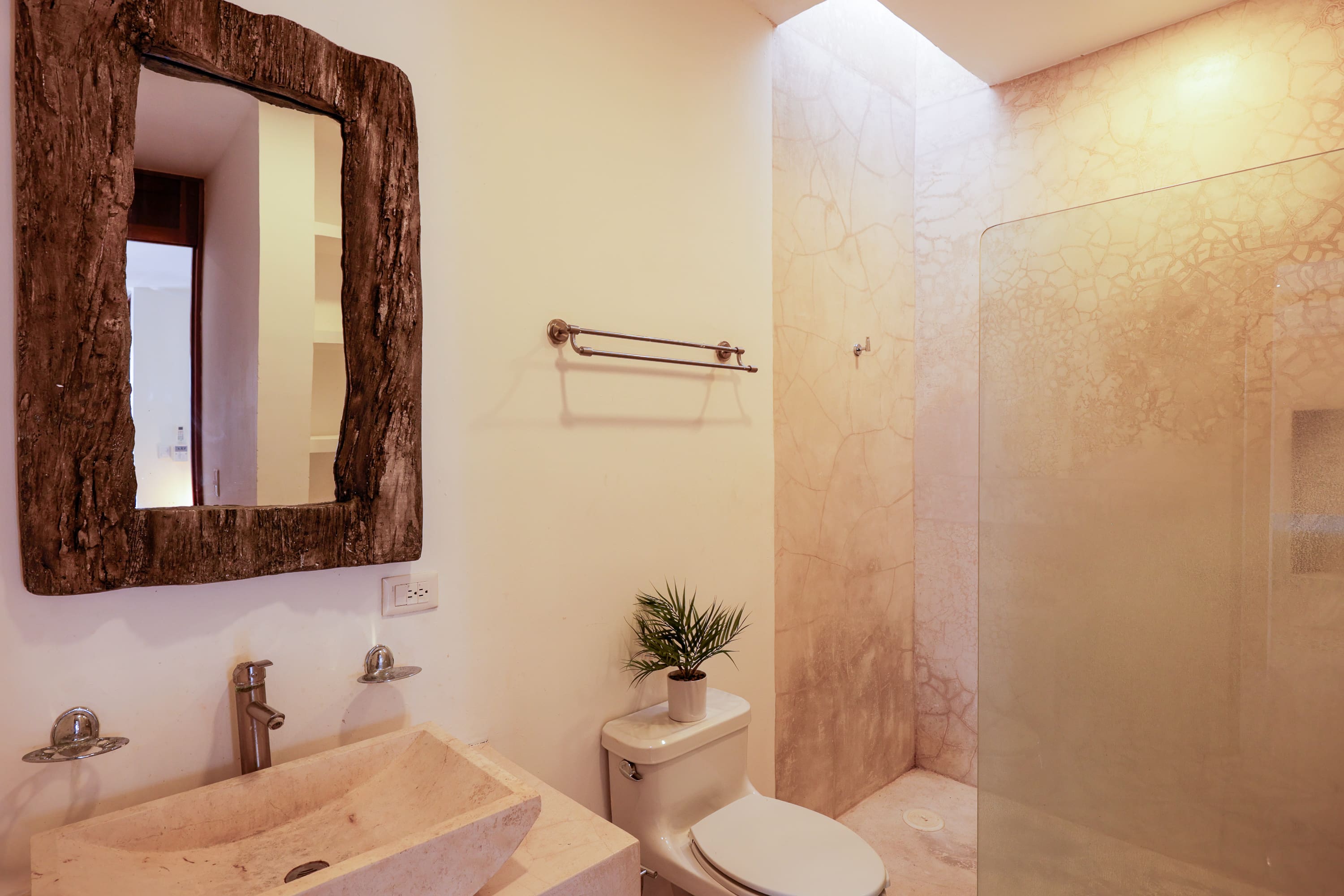 Beige bathroom with wooden mirror and shower