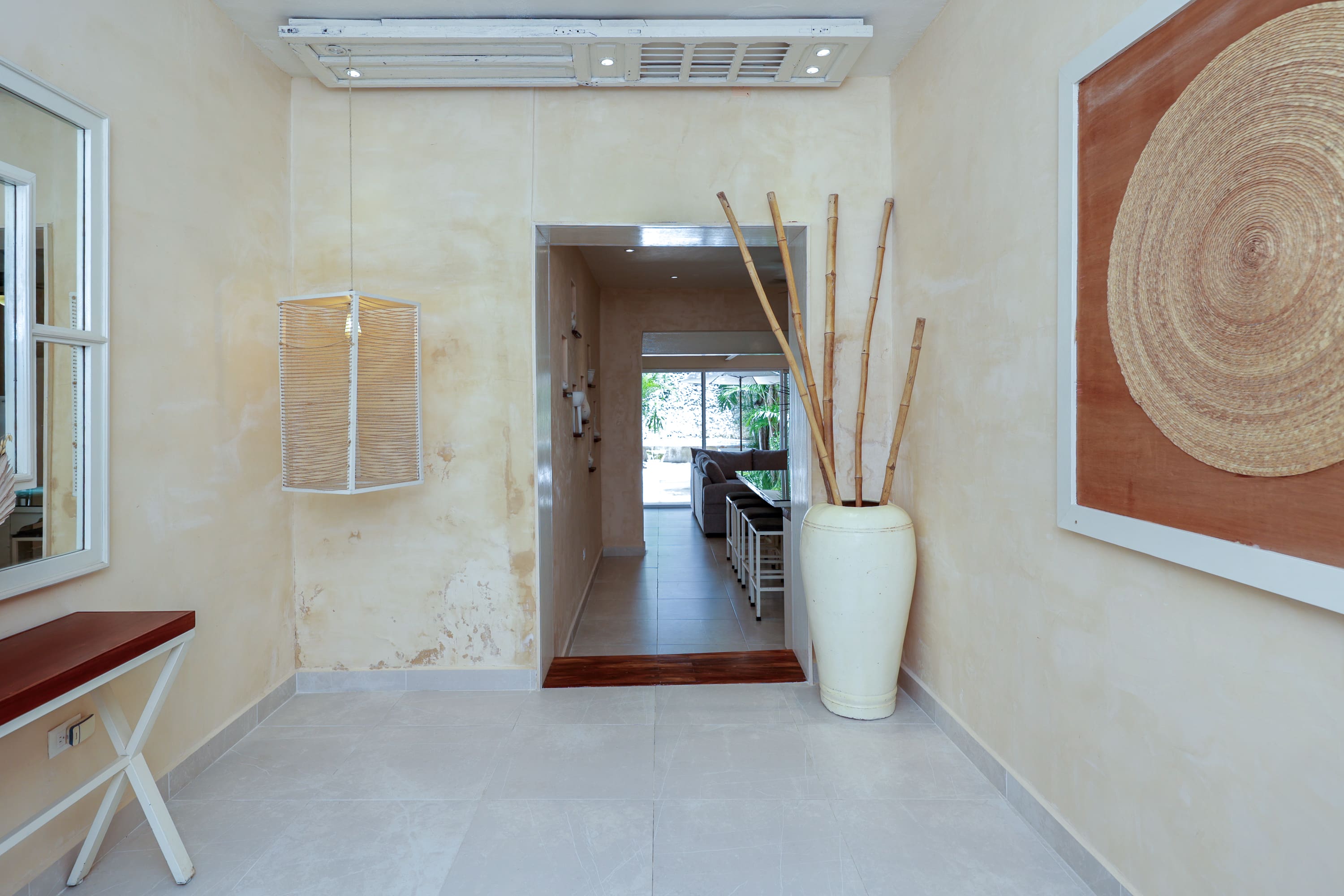 Bright hallway with tall vase and bamboo
