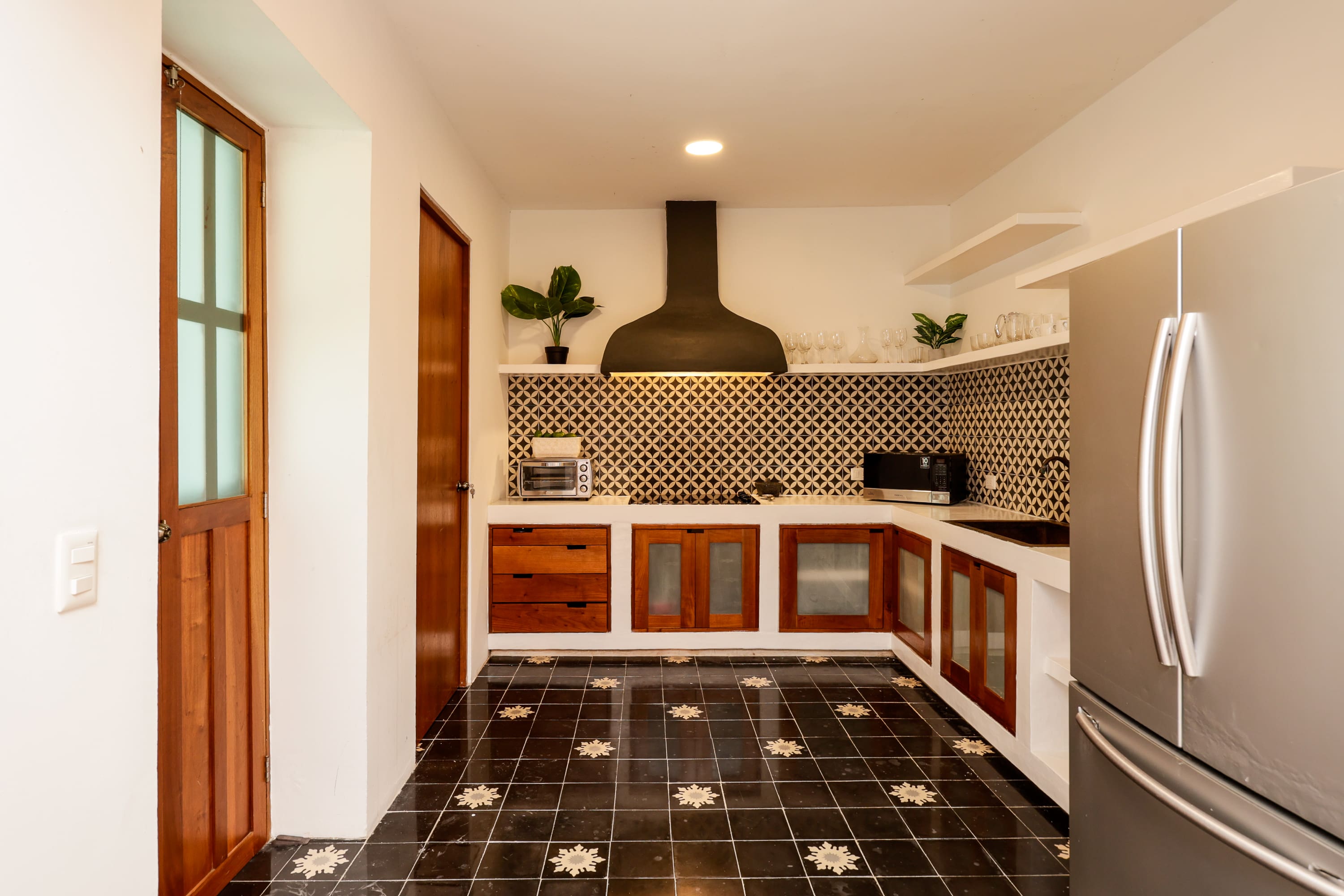 Modern kitchen with patterned black-and-white tiles