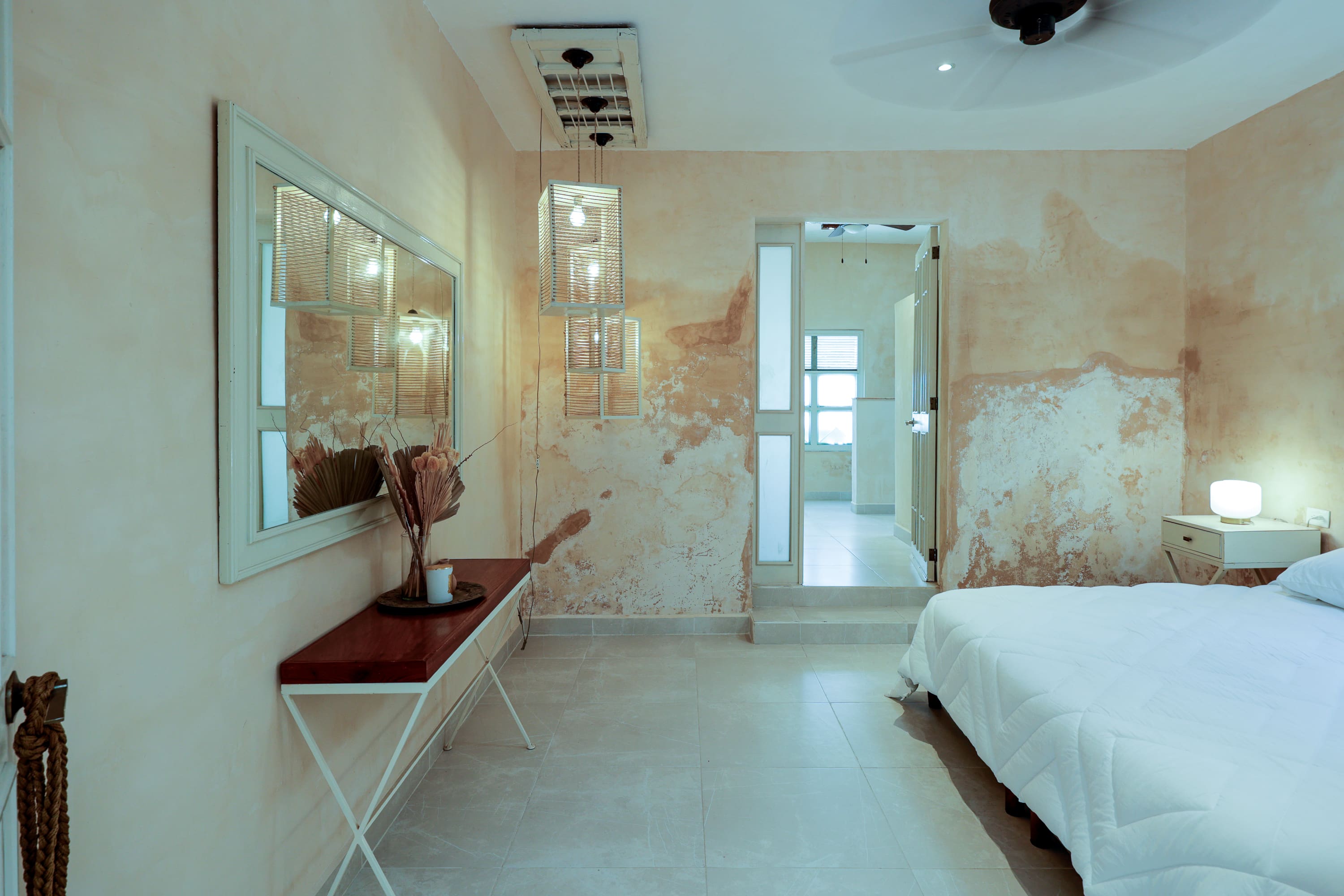 Minimal bedroom with peeling plaster walls