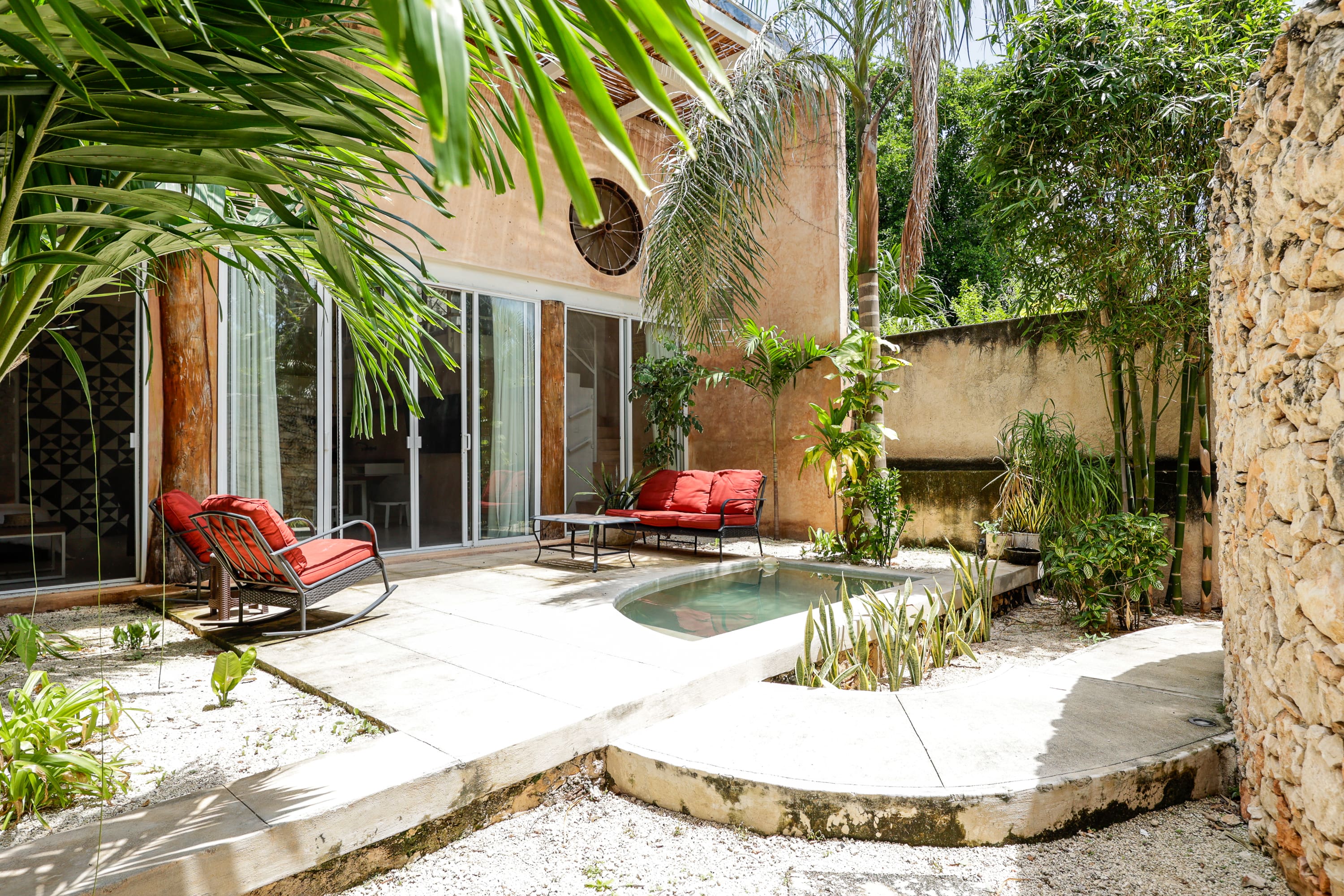 Tropical patio with small plunge pool and loungers