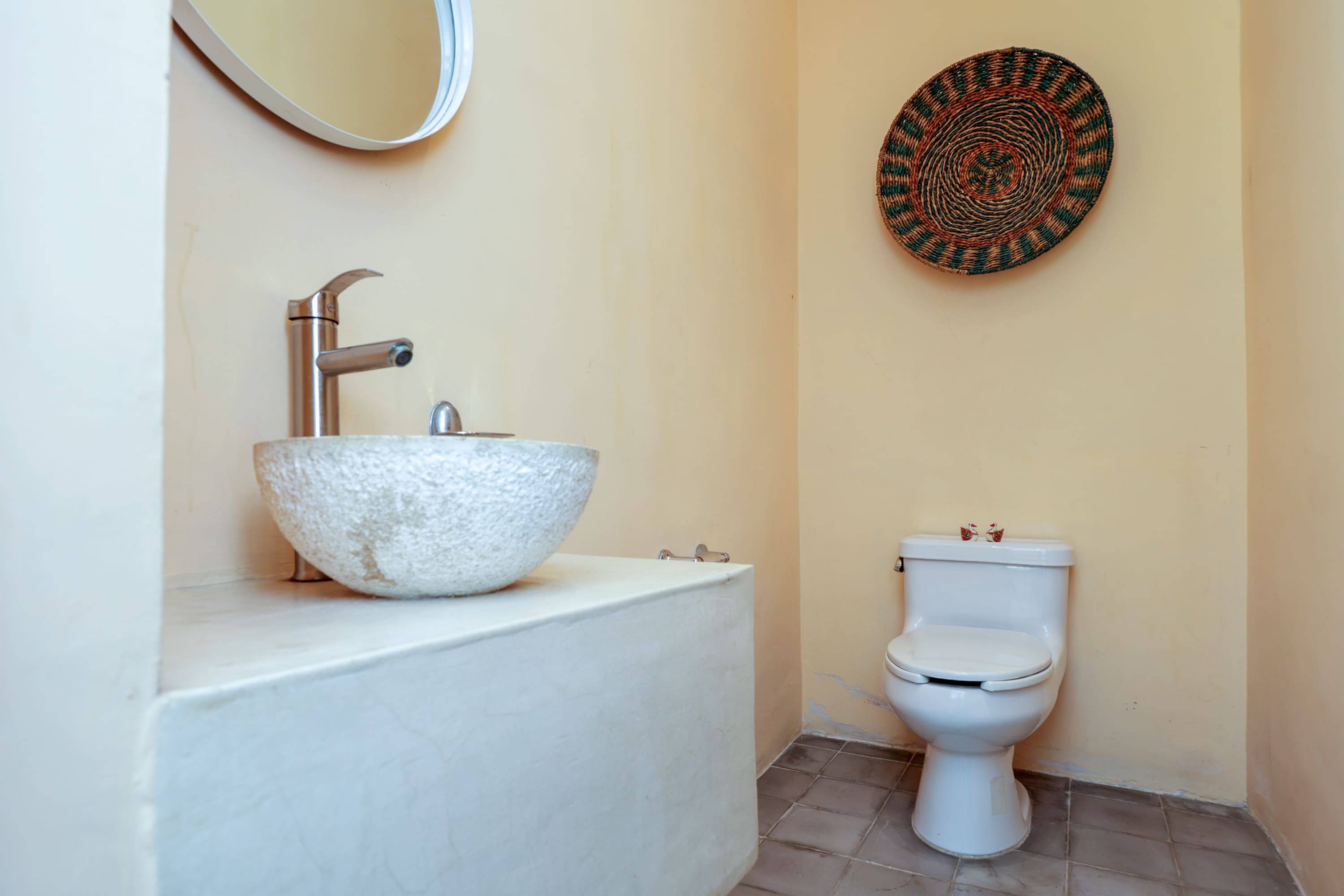 Minimal bathroom with vessel sink and toilet