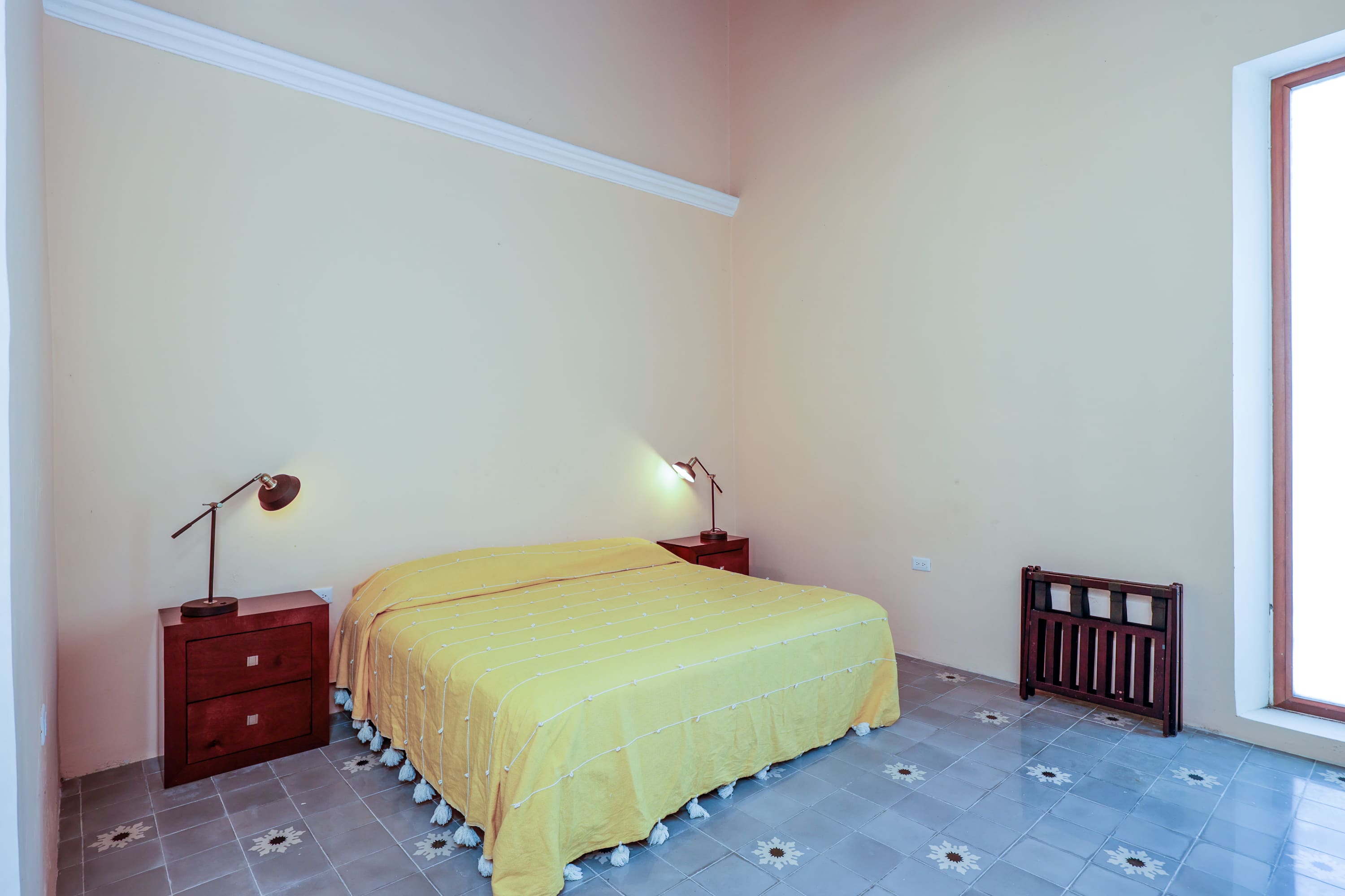 Bedroom with yellow bedspread and lamps