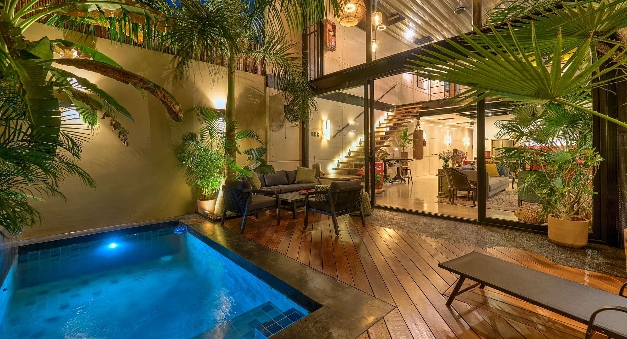Modern tropical patio with pool and seating