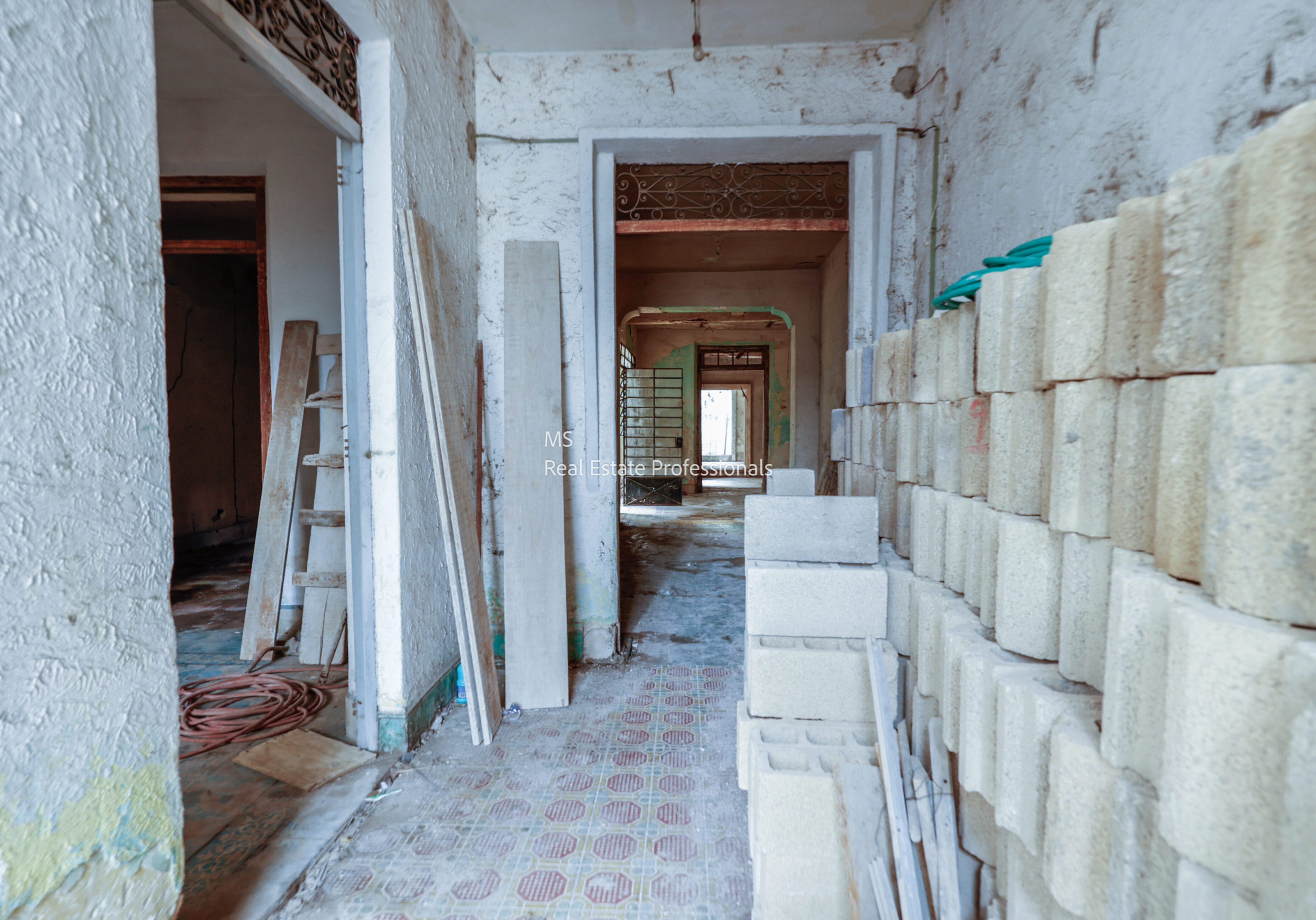 A room with many stacks of bricks and some wood