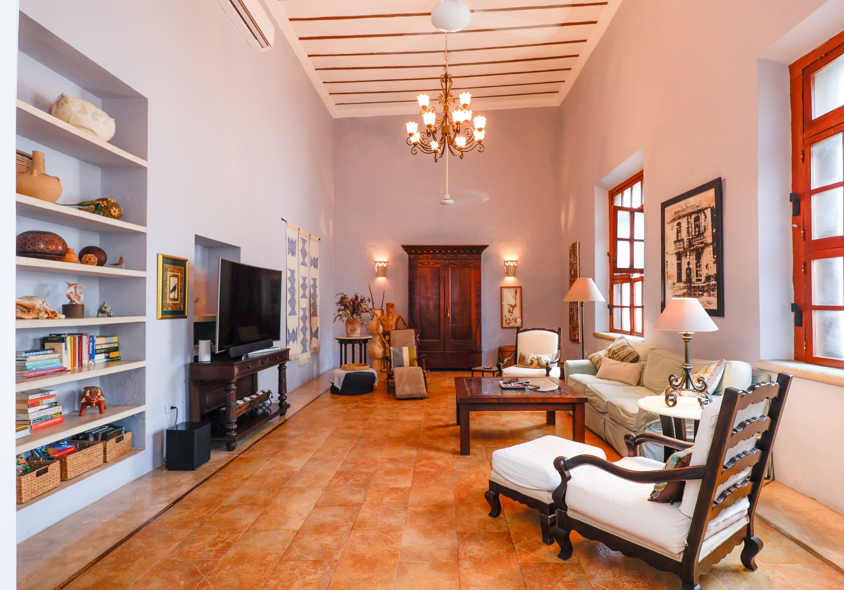 Spacious living room with chandelier and bookshelves